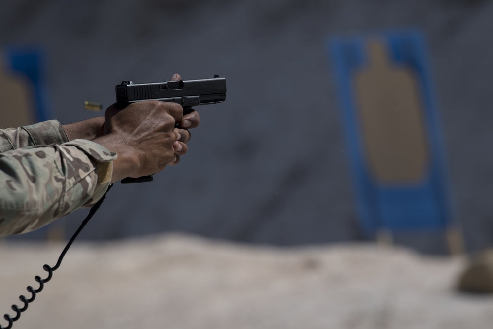 A Jordanian Special Forces member fires a pistol during weapons training with U.S. Air Force Special Tactics Operators
