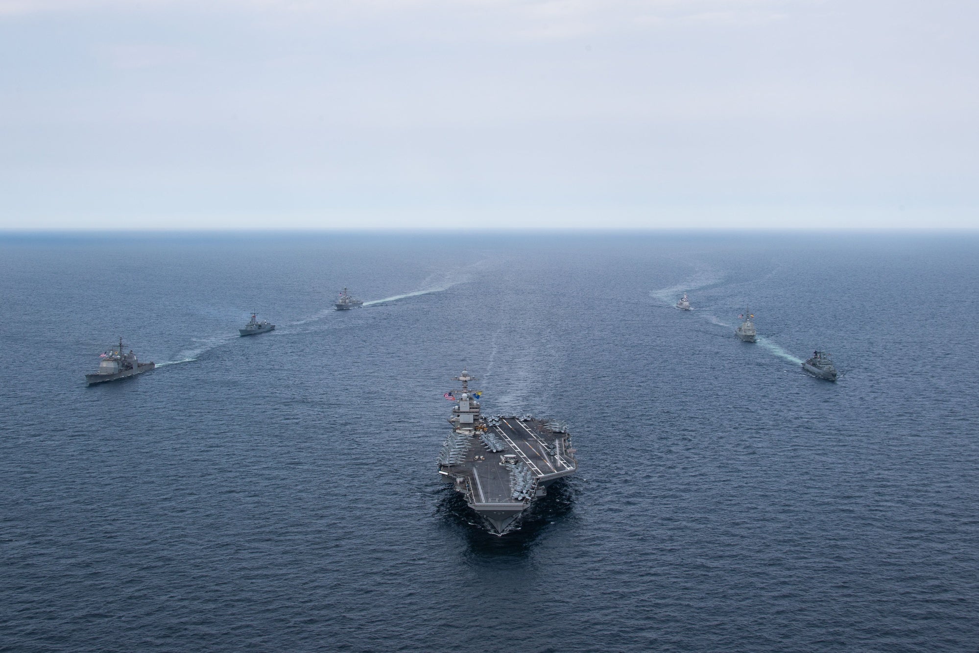 The Gerald R. Ford Carrier Strike Group sails in formation during a passing exercise with Standing NATO Maritime Group 1, North Sea