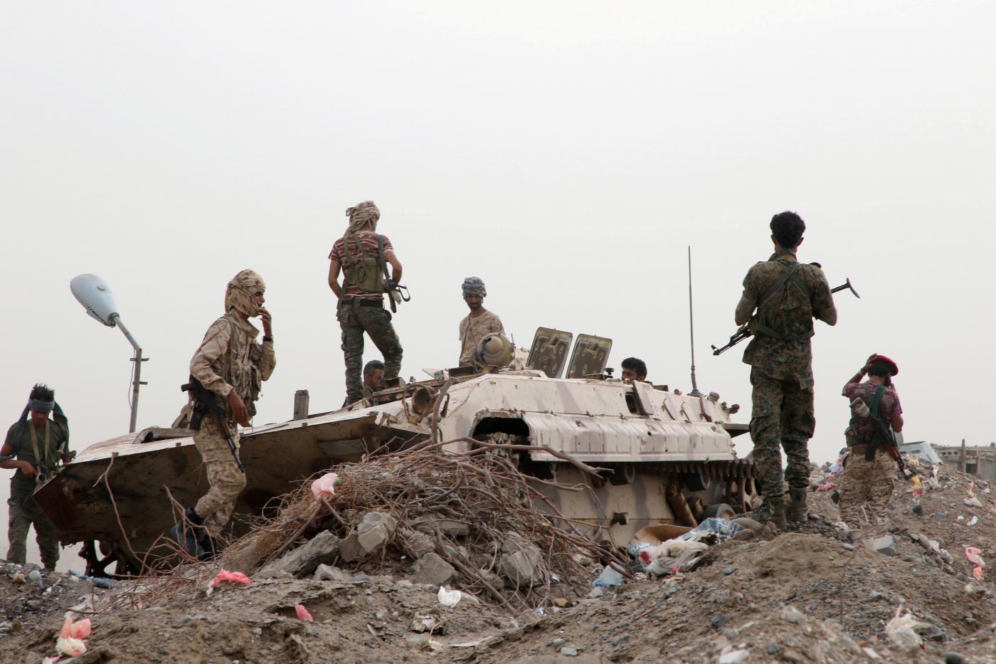 Members of UAE-backed southern Yemeni separatist forces stand by a military vehicle.