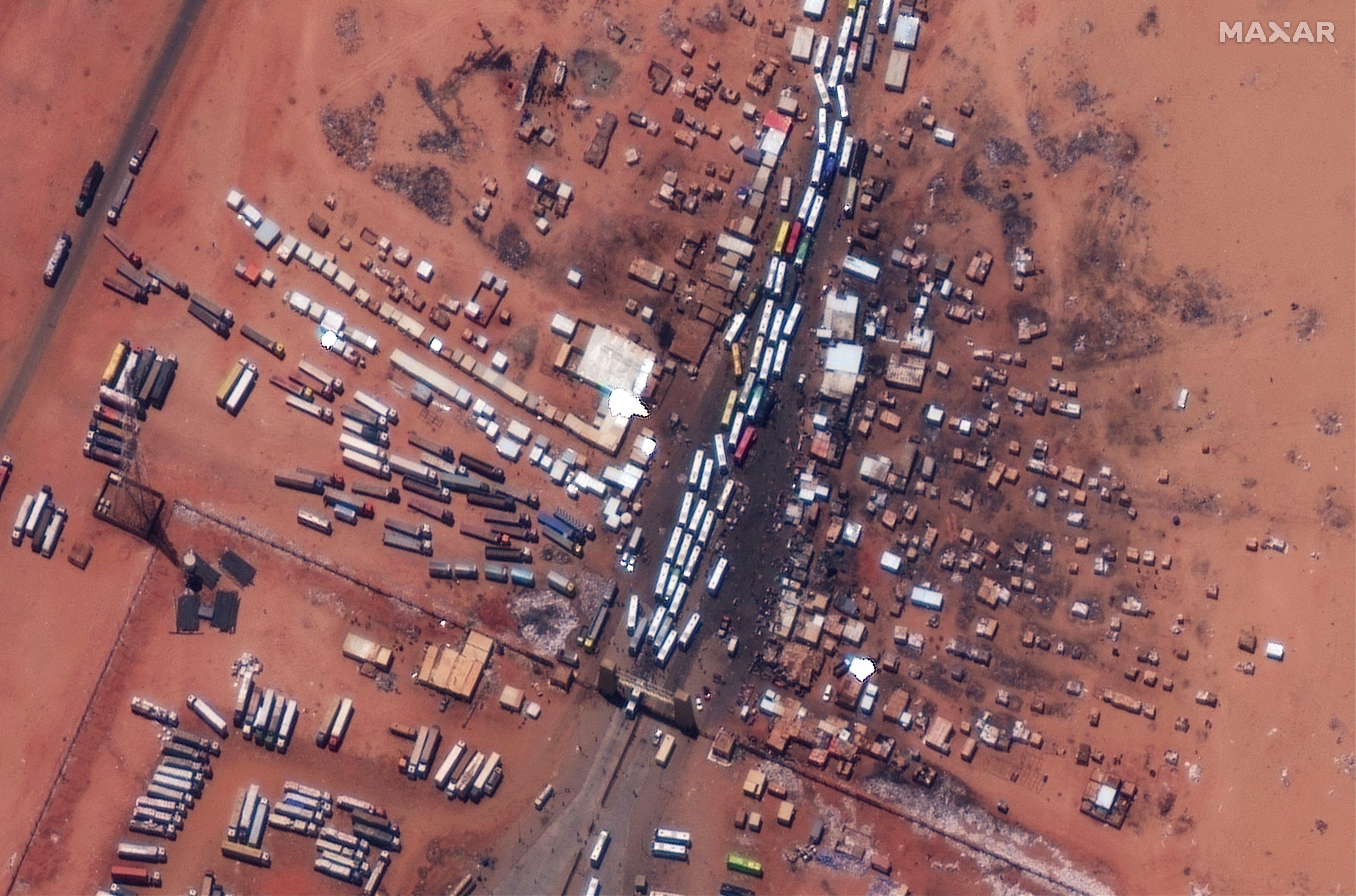 A satellite view shows buses as they wait at the Argeen border between Egypt and Sudan