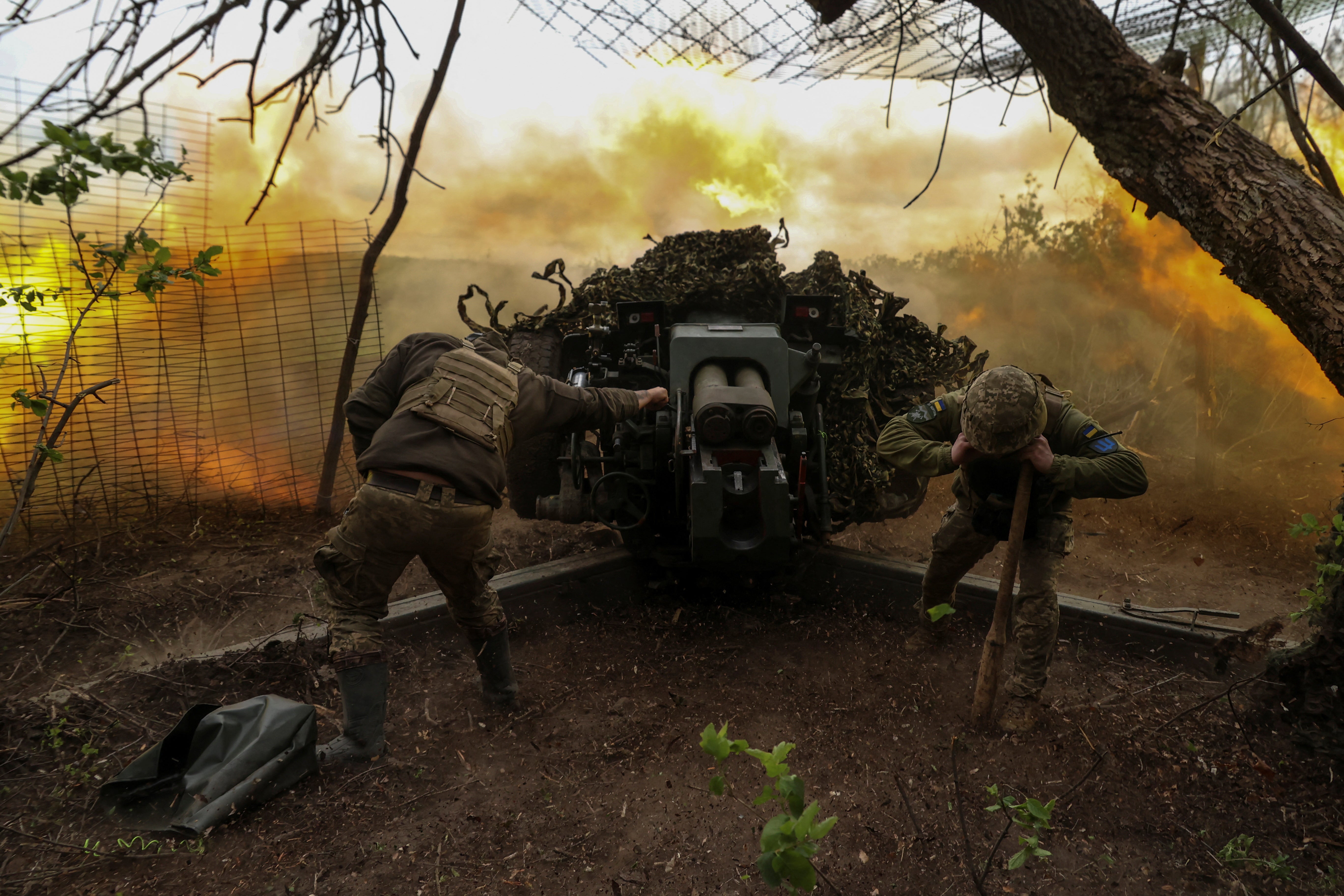 Ukrainian servicemen of the 10th Mountain Assault Brigade 'Edelweiss' fire a D-30 howitzer towards Russian troops at a position in a front line, amid Russia’s attack on Ukraine