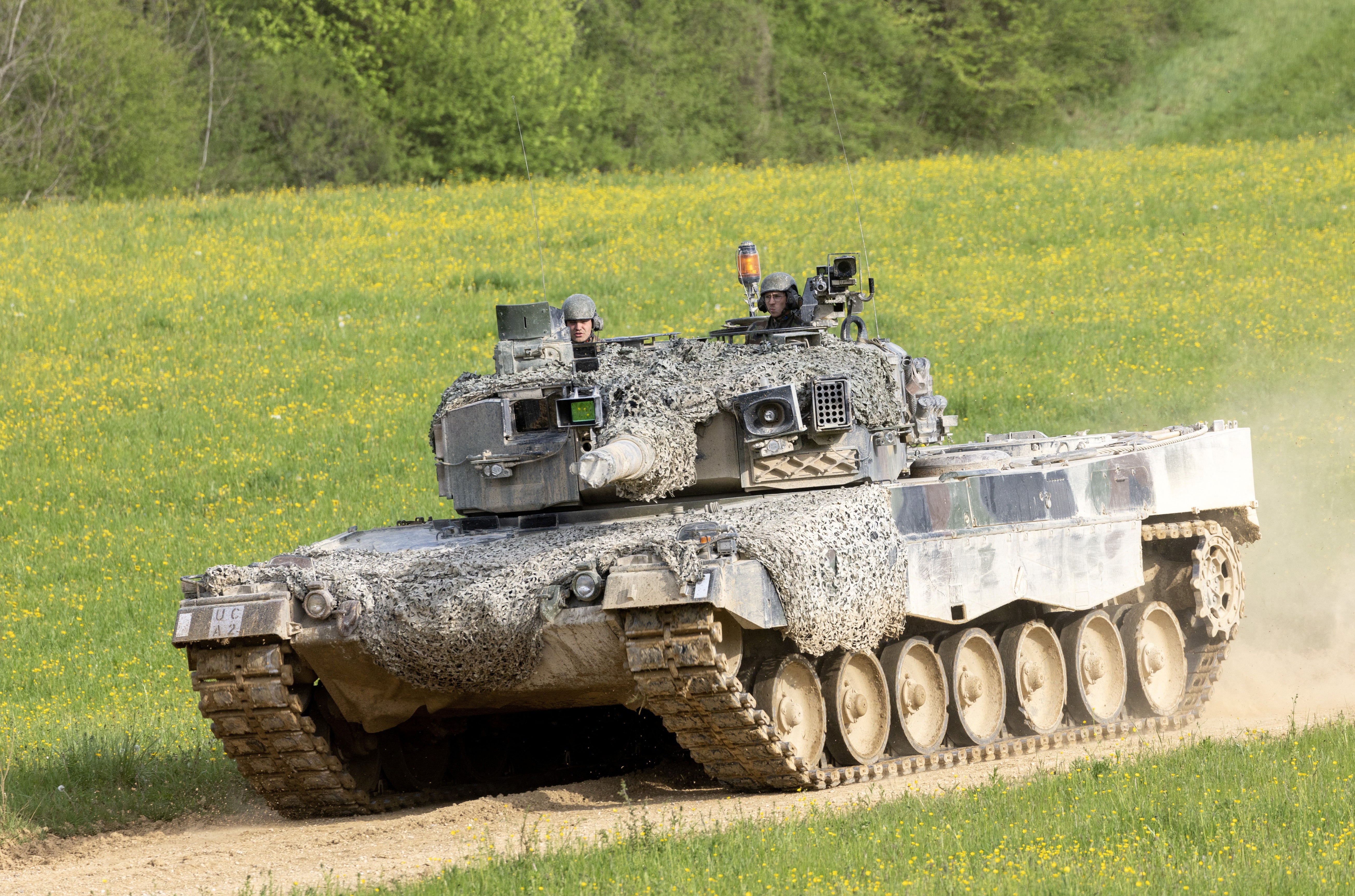 Recruits of the Swiss army Tank School 21 perform an attack exercise with the Leopard 2 tank
