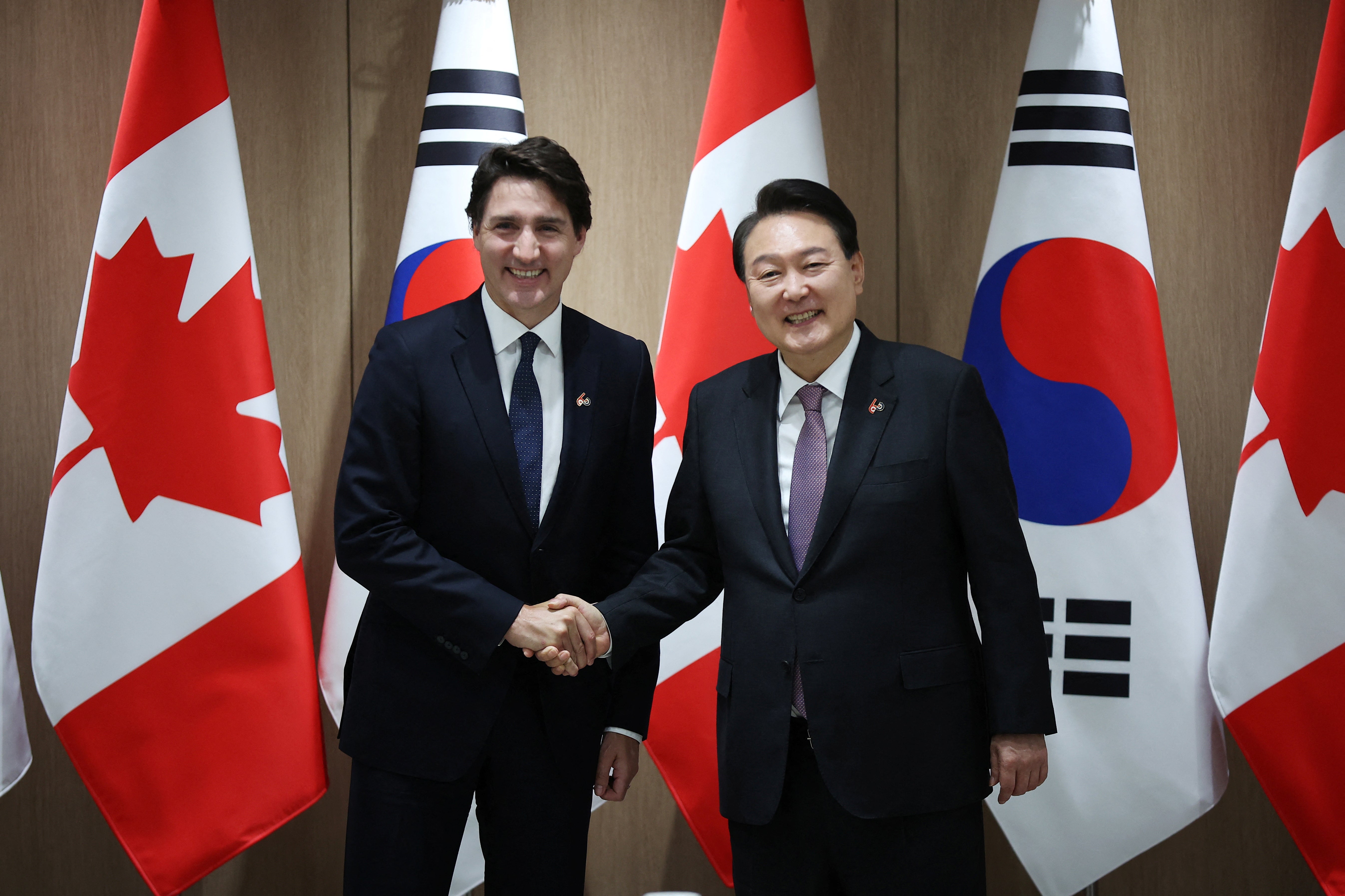 Canada’s Prime Minister Justin Trudeau shakes hands with South Korea’s President Yoon Suk Yeol during their meeting at the Presidential Office in Seoul