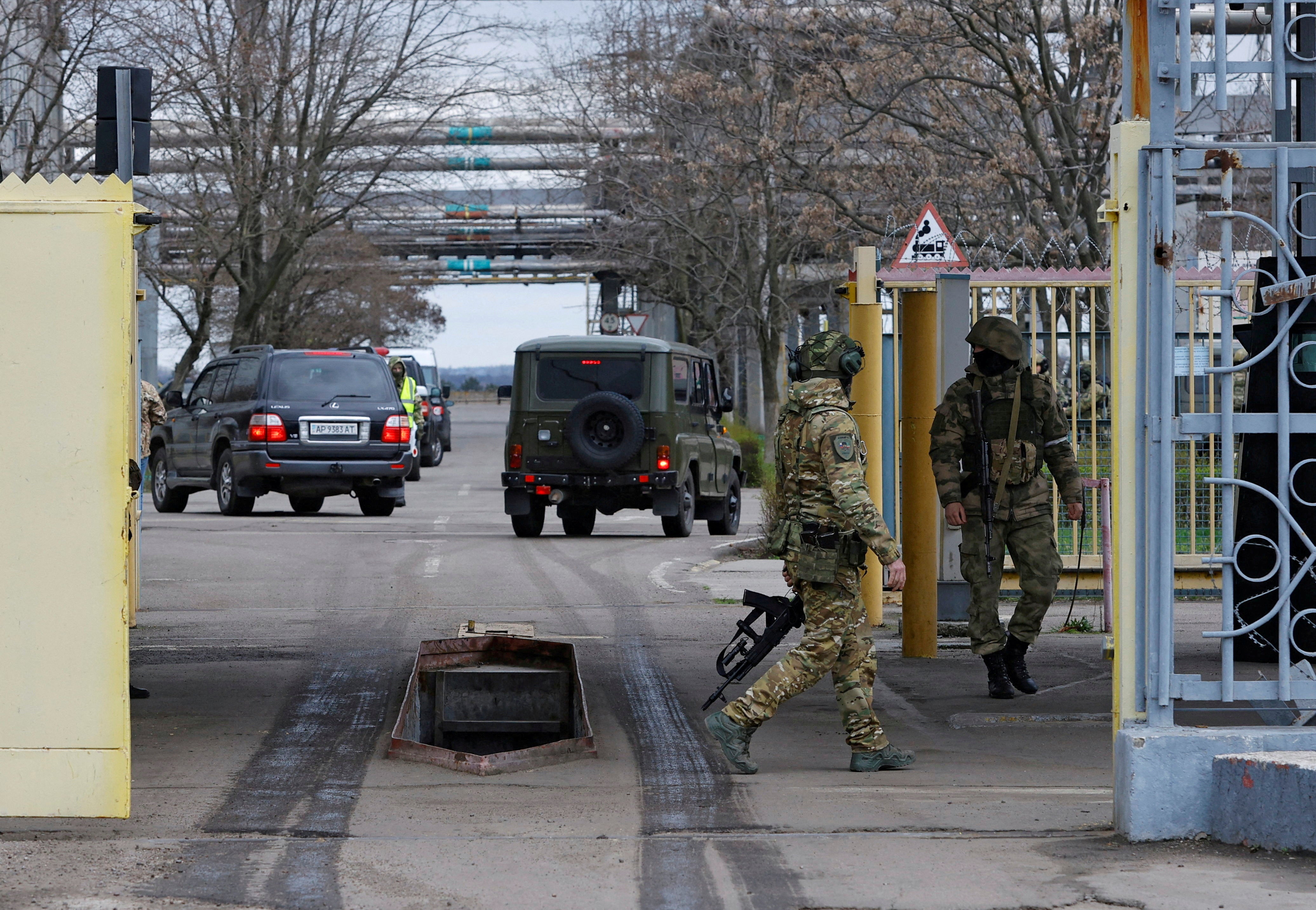 Russian service members guard the entrance to the Zaporizhzhia Nuclear Power Plant during a visit of the International Atomic Energy Agency (IAEA) 