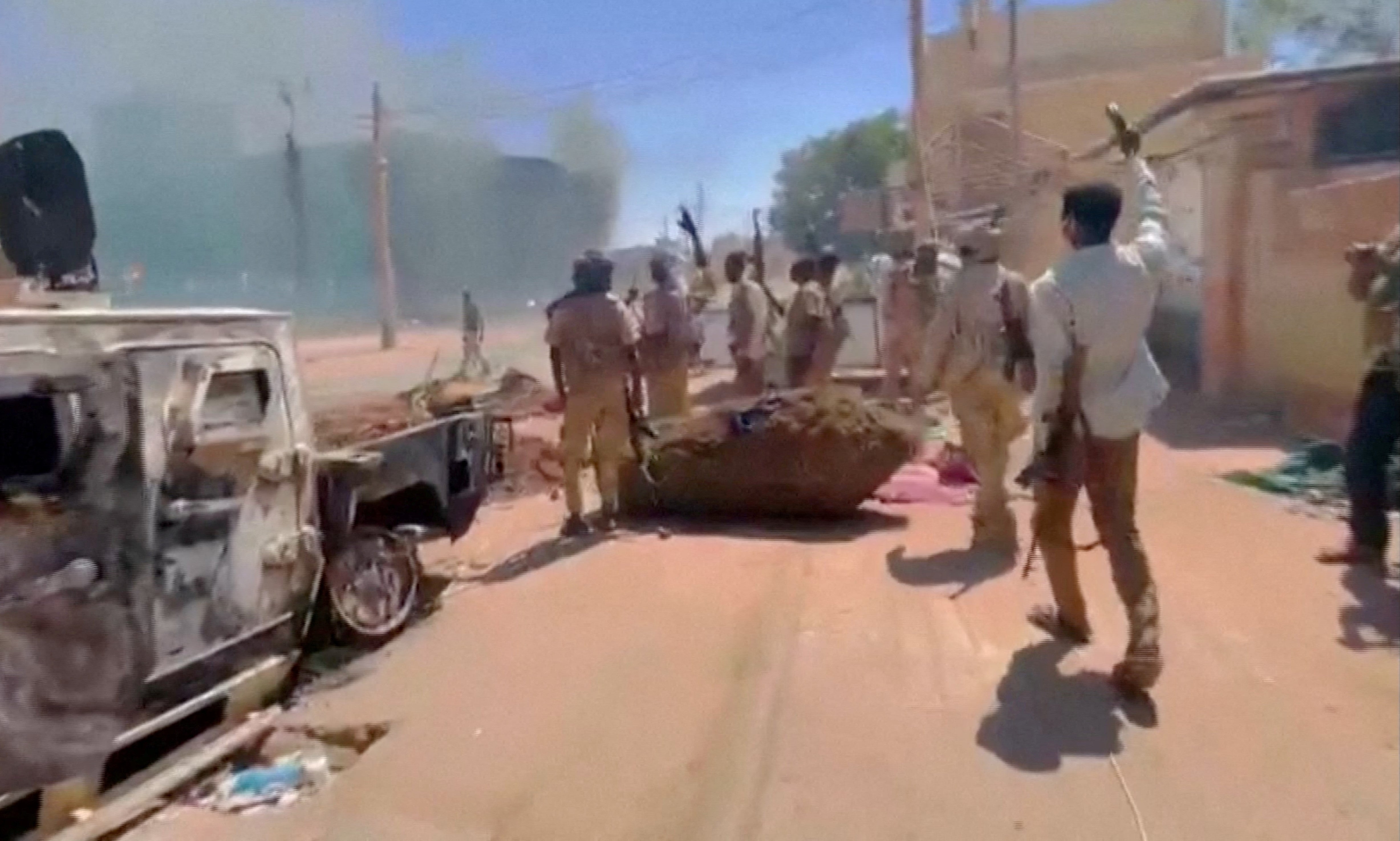 RSF fighters stand near the damaged Air Defence Forces command center in Khartoum, Sudan May 17, 2023, in this screen grab obtained from a social media video.