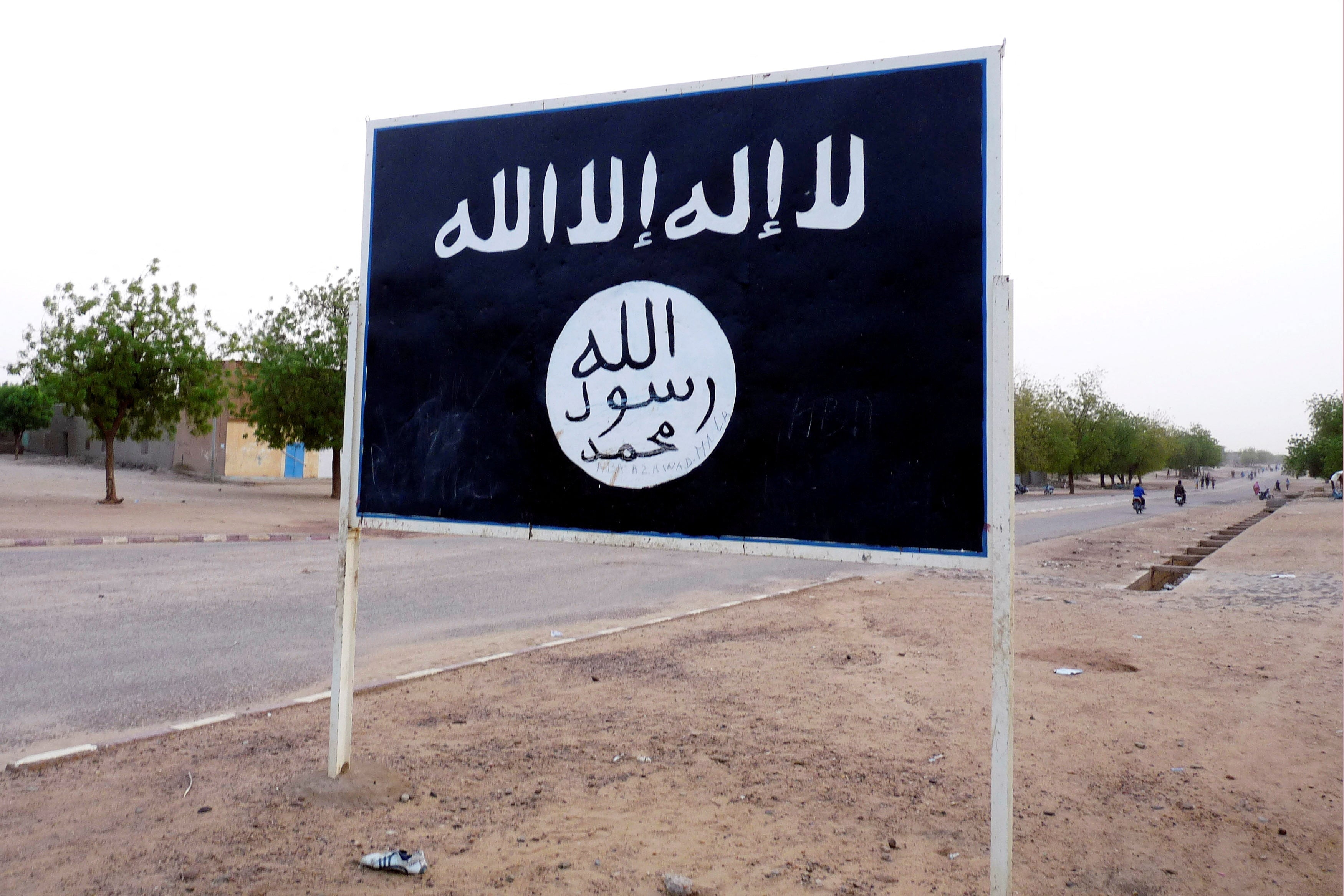 The black flag of the Ansar Dine Islamic group is posted on a road sign in Kidal in northeastern Mali,