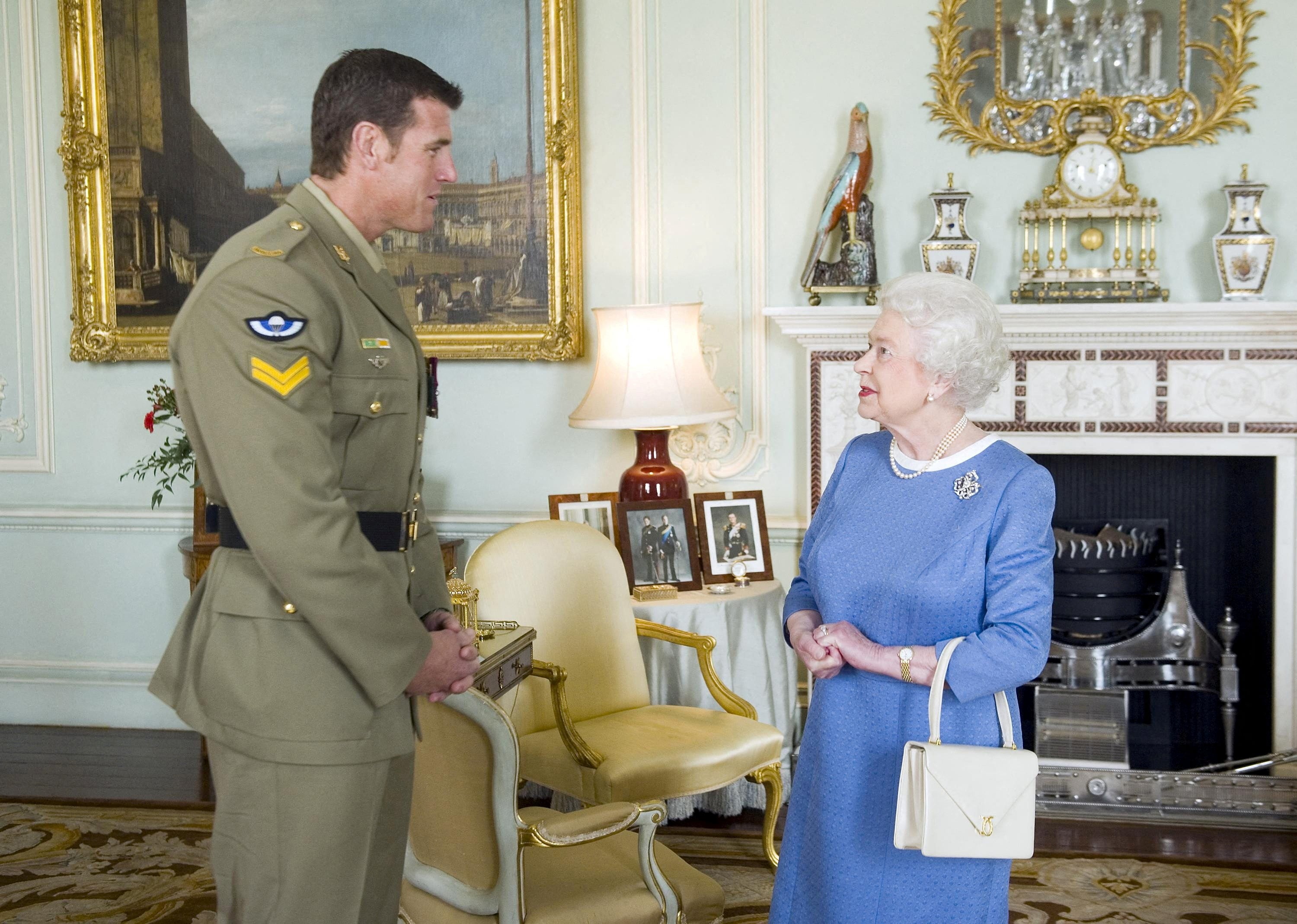 Britain's Queen Elizabeth II greets Australian SAS Corporal Ben Roberts-Smith (L), who was recently awarded the Victoria Cross for Australia, during an audience at Buckingham Palace in London