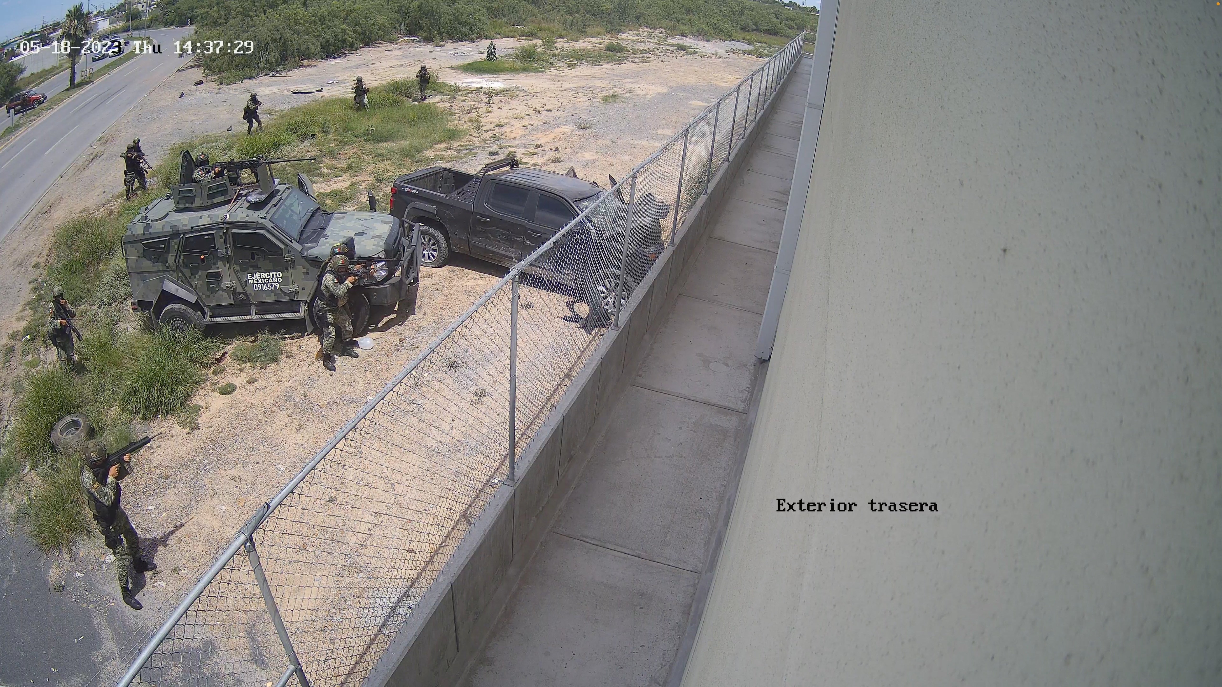 Soldiers with weapons approach a pick-up truck after it crashed into a wall at high speed in Nuevo Laredo, Tamaulipas