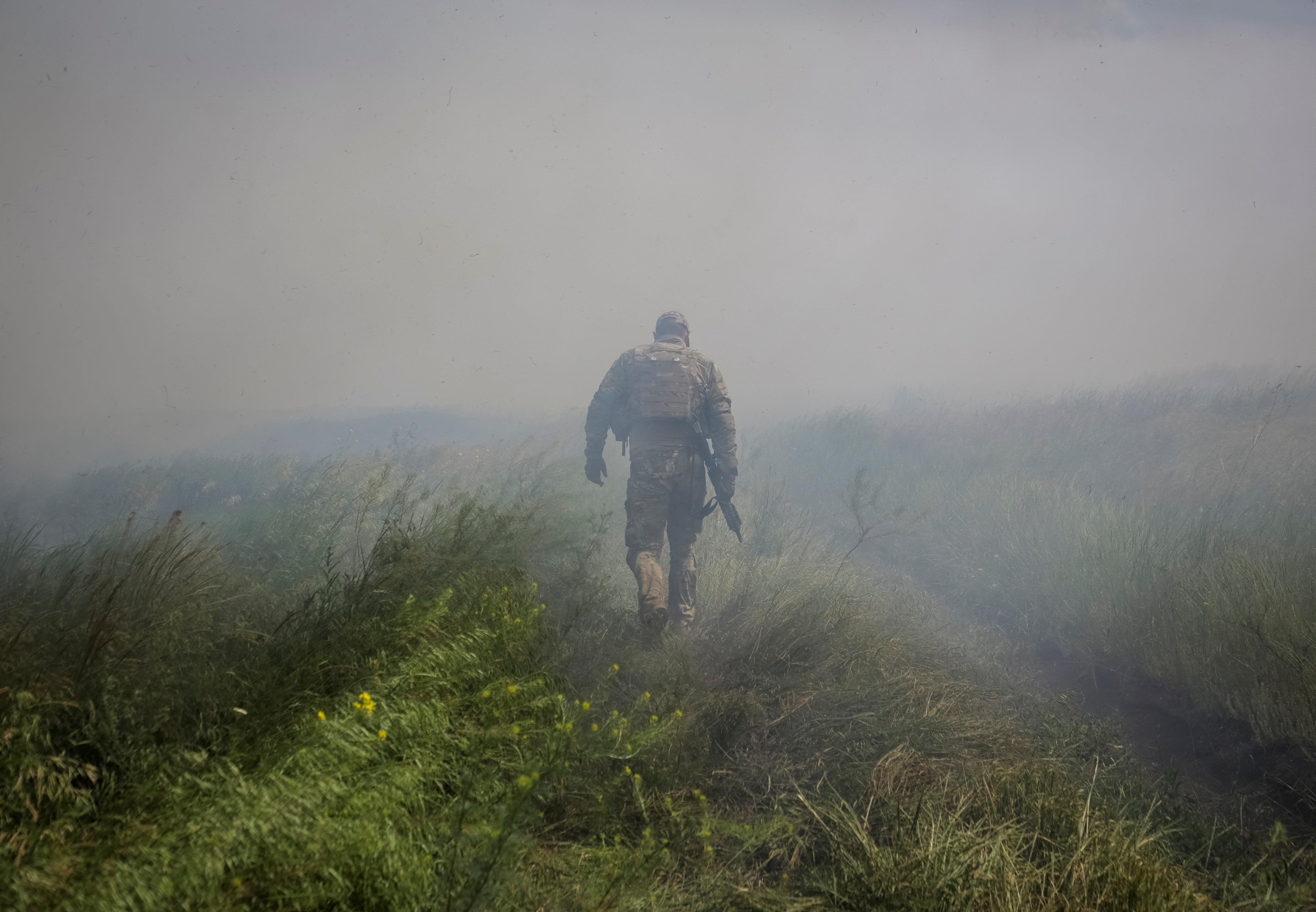 A Ukrainian service member is seen outside the recaptured village of Neskuchne in Donetsk region, Ukraine
