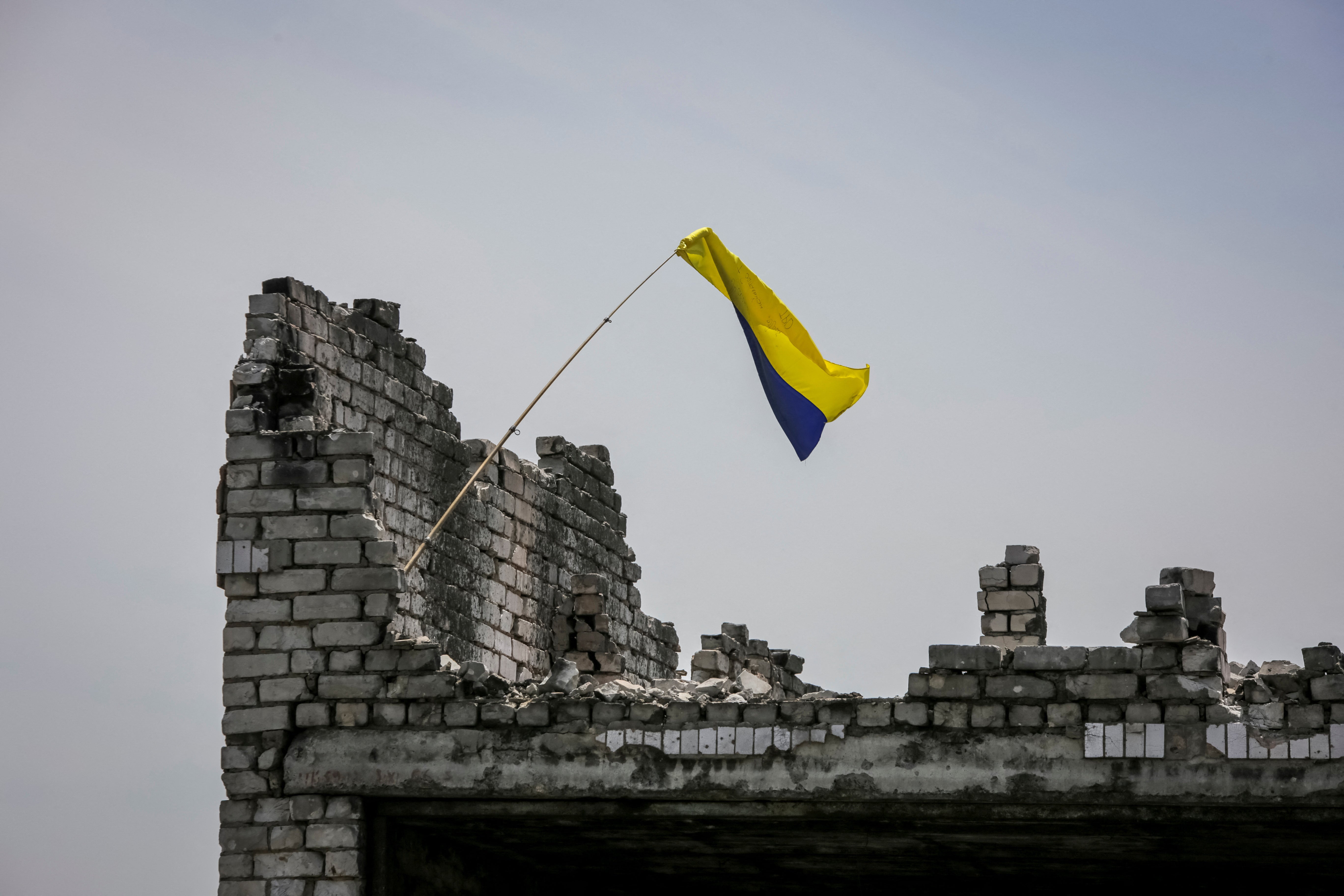  A Ukrainian national flag is seen near the front line in the recaptured village Neskuchne in Donetsk region, Ukraine