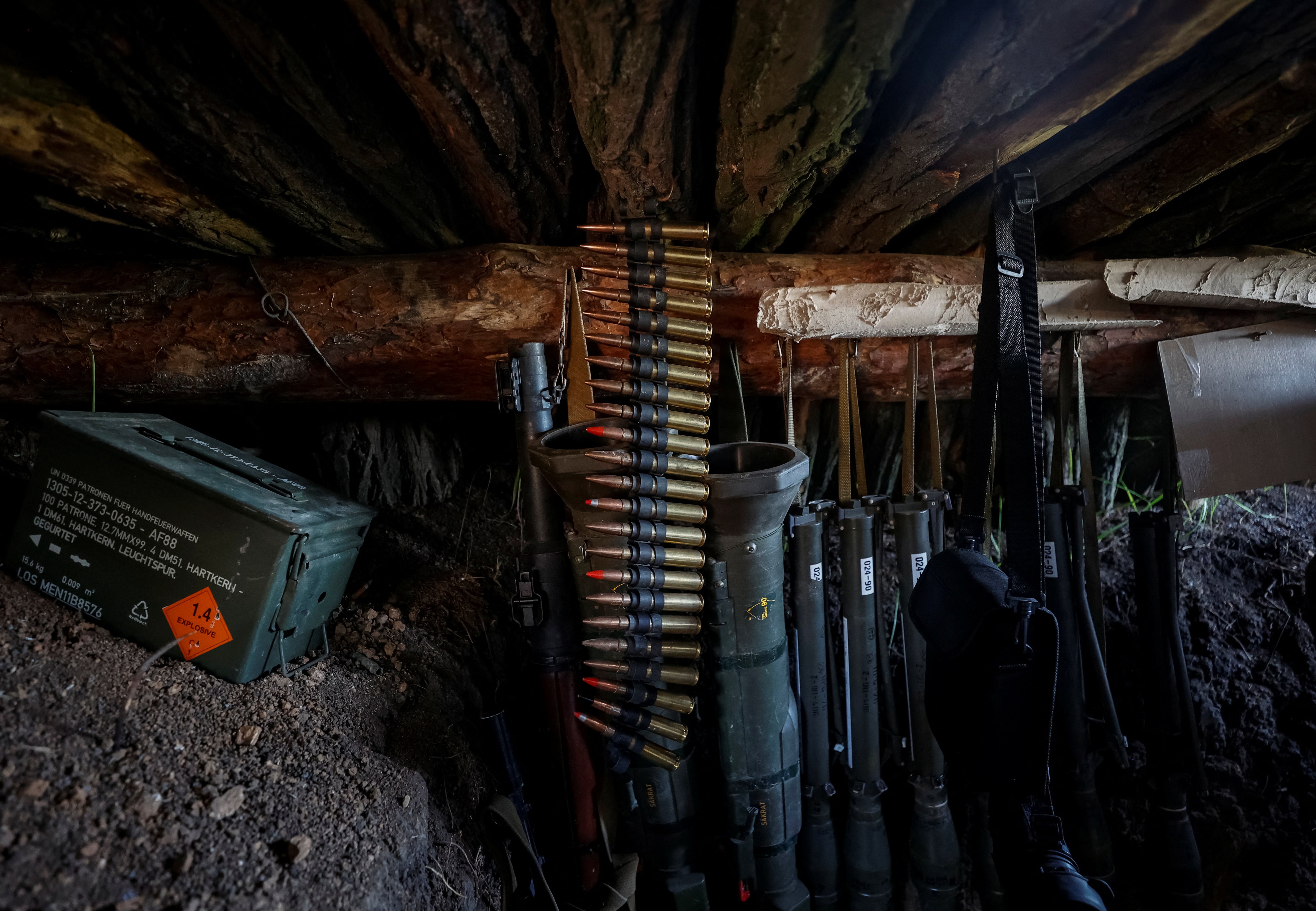 Weapons of Ukrainian service members are seen in a trench at position at a front line, amid Russia's attack on Ukraine