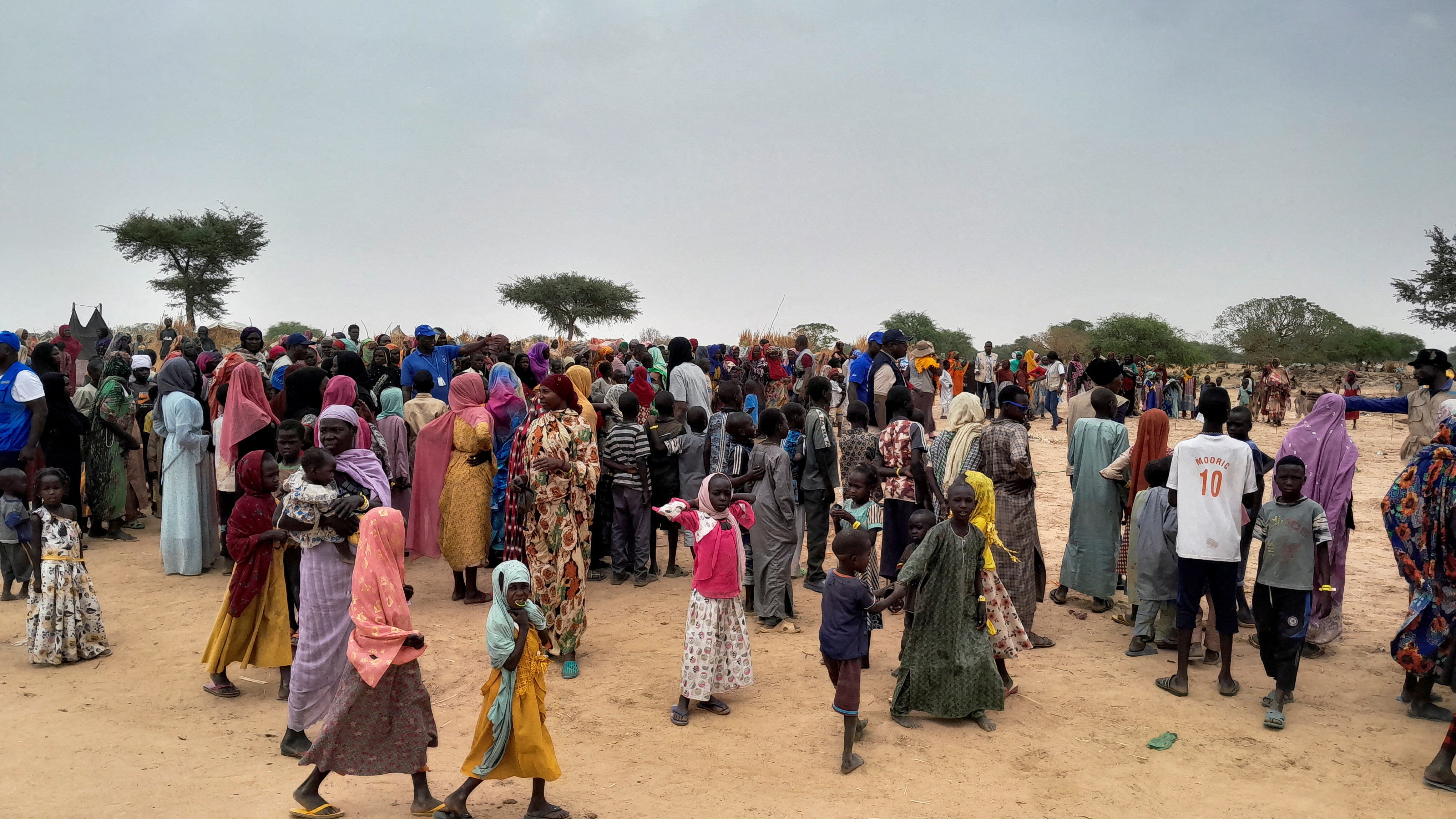 Sudanese people, who fled the violence in their country and newly arrived, wait to be registered at the camp