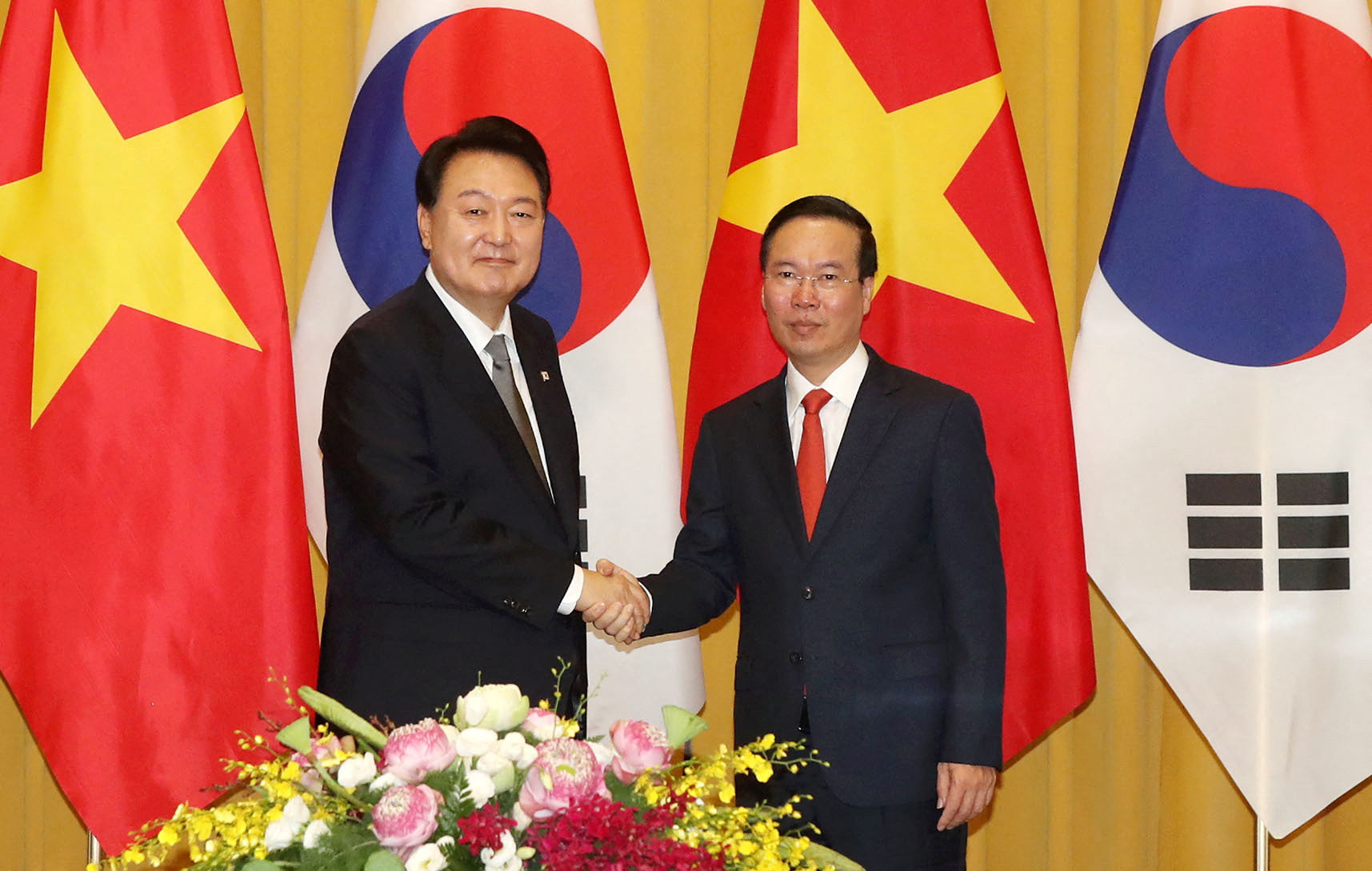 South Korea's President Yoon Suk Yeol shakes hands with Vietnam's President Vo Van Thuong