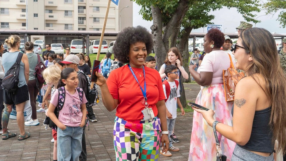 Parents and students arrive at Sullivans Elementary School at Fleet Activities Yokosuka, Japan, on Aug. 17, 2026, as Defense Department schools began the 2026-27 academic year under new restrictions on student phones and smartwatches.
