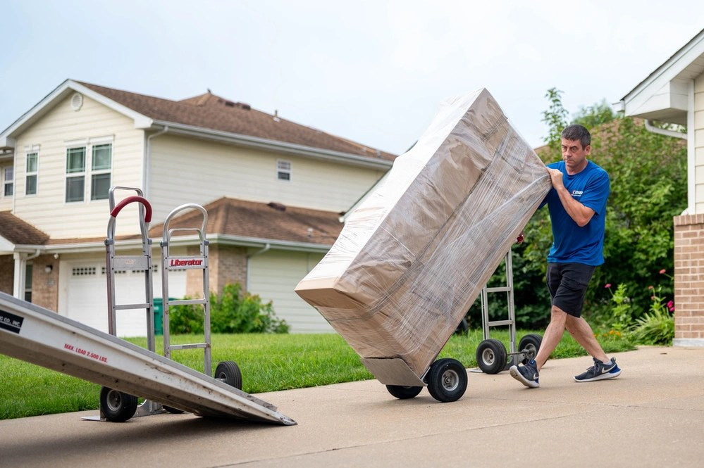 A mover loads a box into a moving truck during a household-goods pickup for a permanent change of station at Scott Air Force Base, Illinois, on July 18, 2025. U.S. Air Force photo by Staff Sgt. Stephanie Henry.