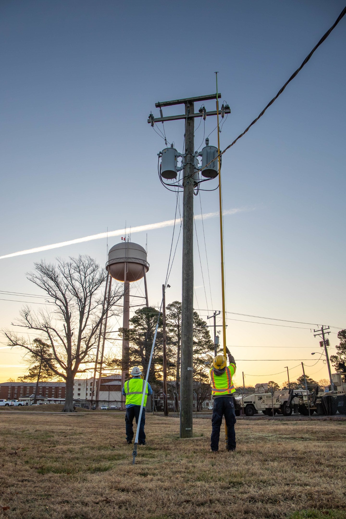 Technicians inspect electrical infrastructure during a power-outage exercise at Joint Base Langley-Eustis, Virginia. The image is illustrative. Navy families near Naval Station Norfolk have reported repeated outages lasting as long as 15 hours. U.S. Air