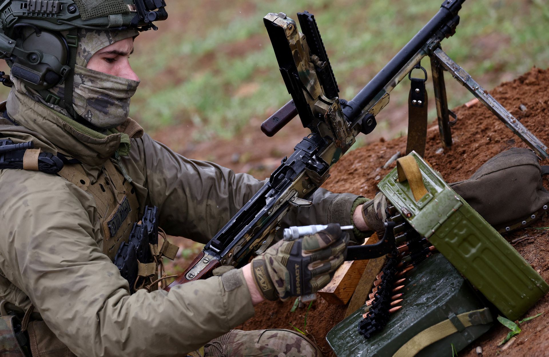 A member of the Ukrainian special forces manipulates his machine gun prior to a mission