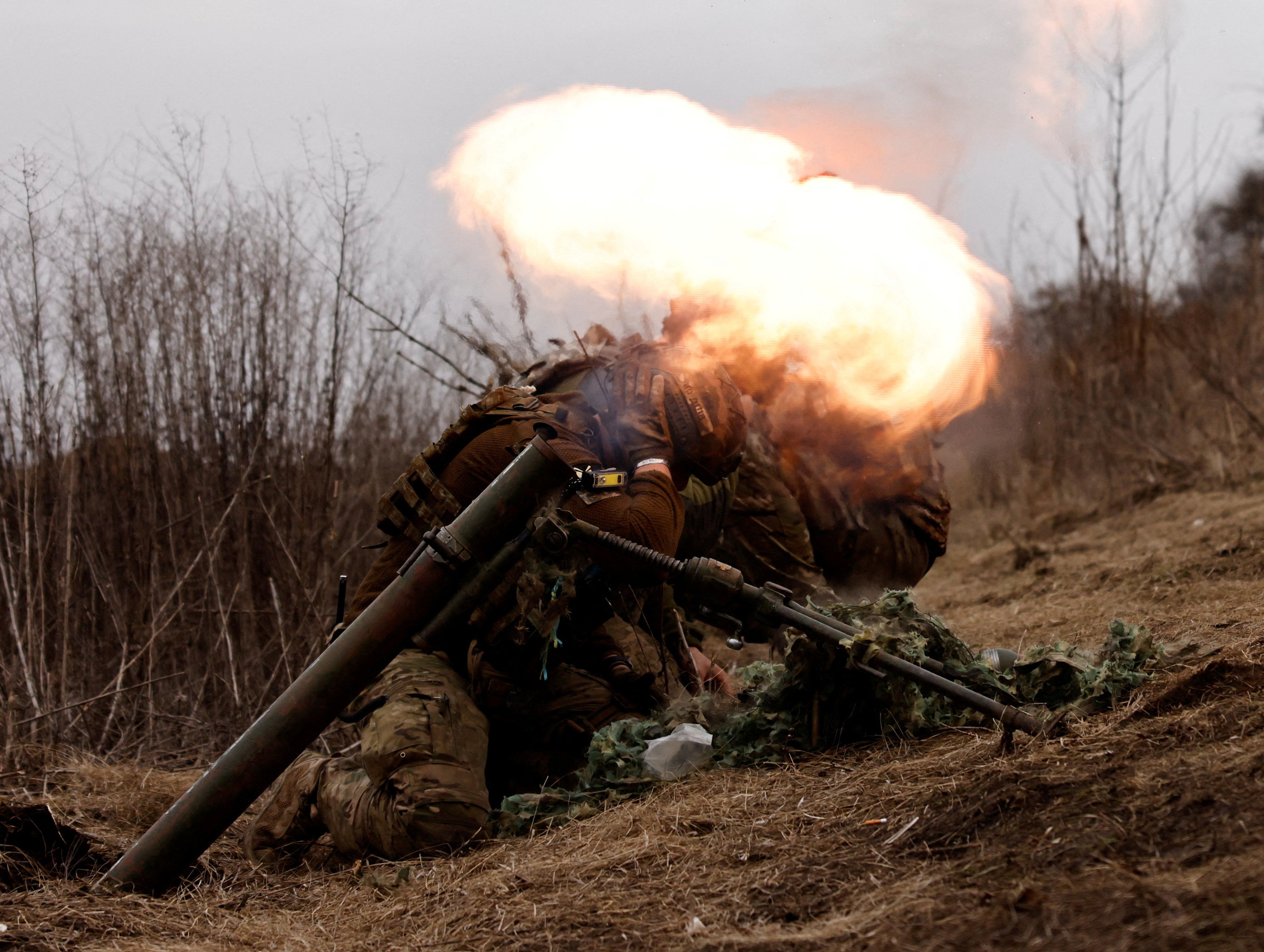 Ukrainian soldiers of the Paratroopers' of 80th brigade fire a mortar at a frontline position near Bakhmut
