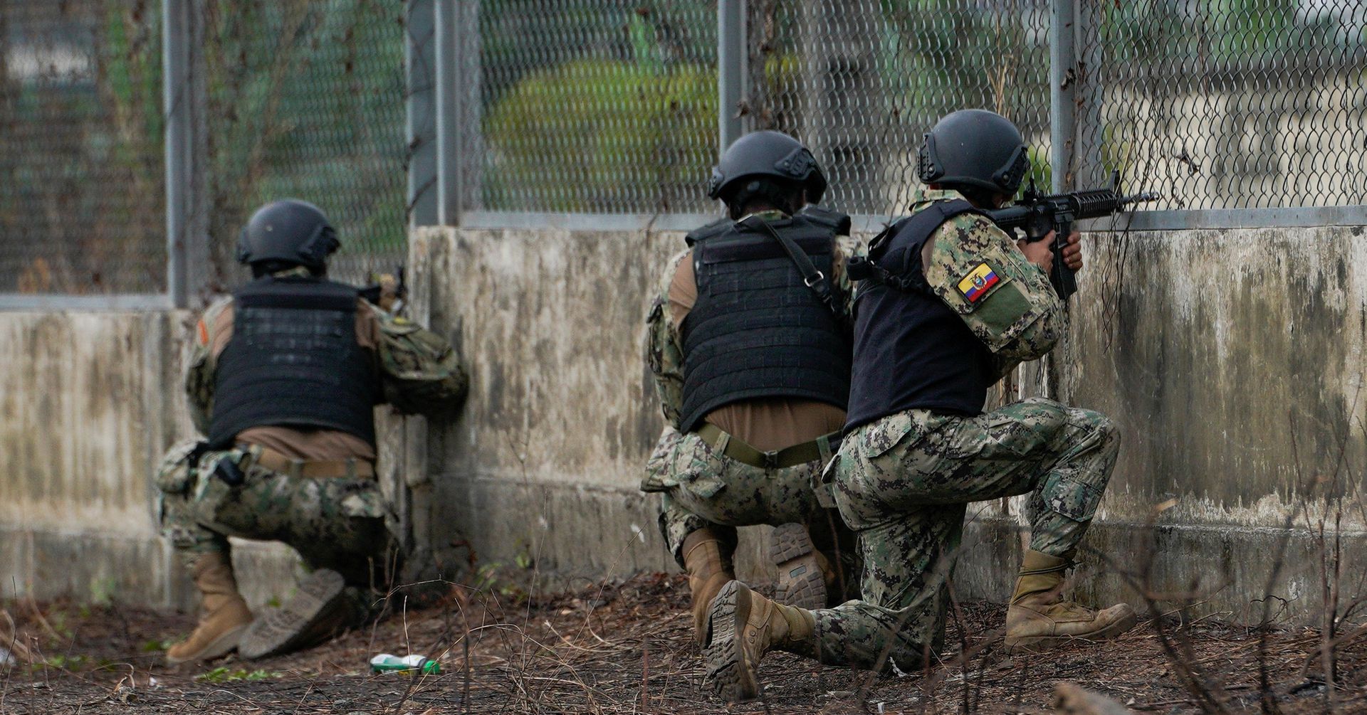 oldiers guard a gate after several inmates were killed in fights between gangs, in Guayaquil