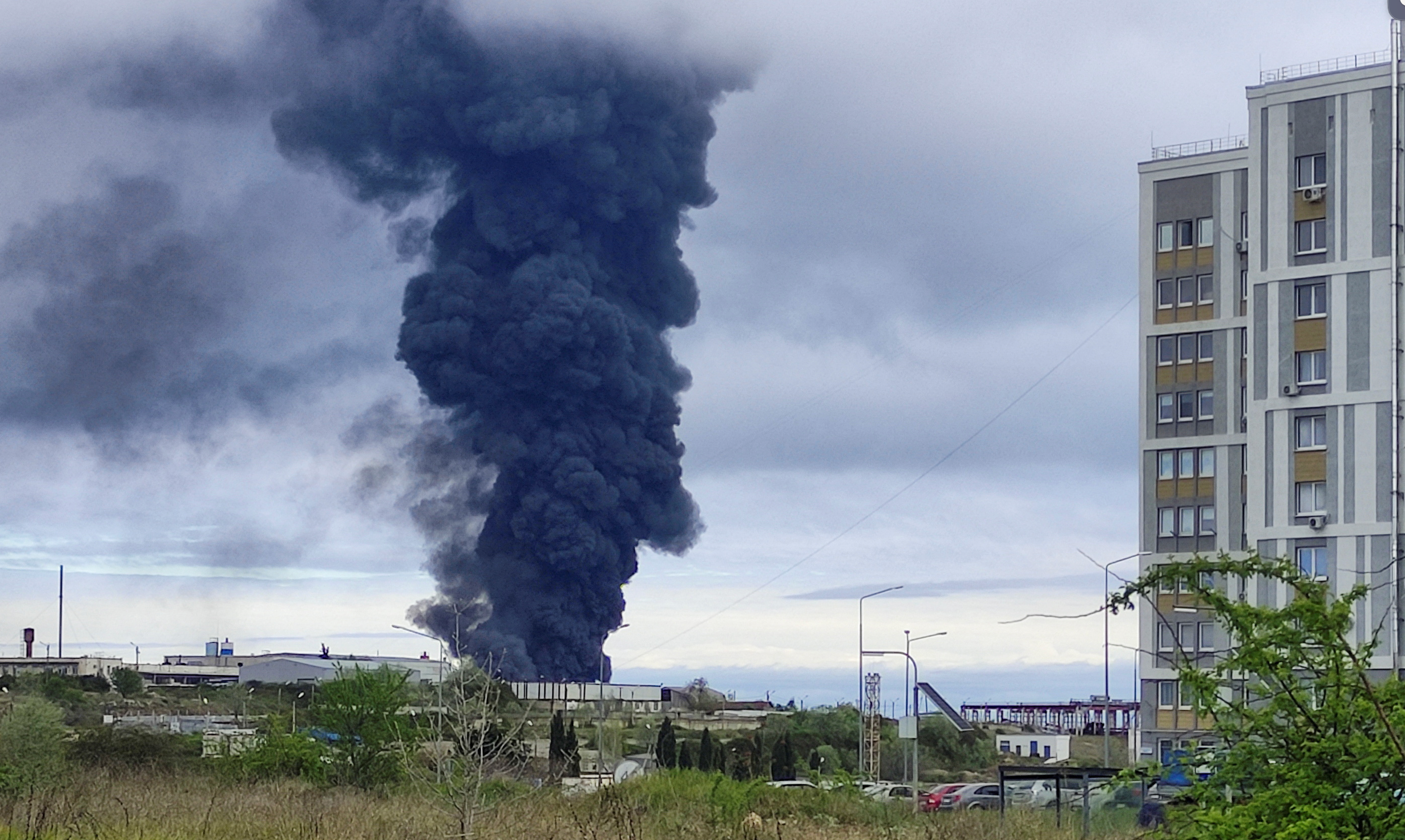 Smoke rises over a fuel tank following an alleged drone attack in Sevastopol, Crimea