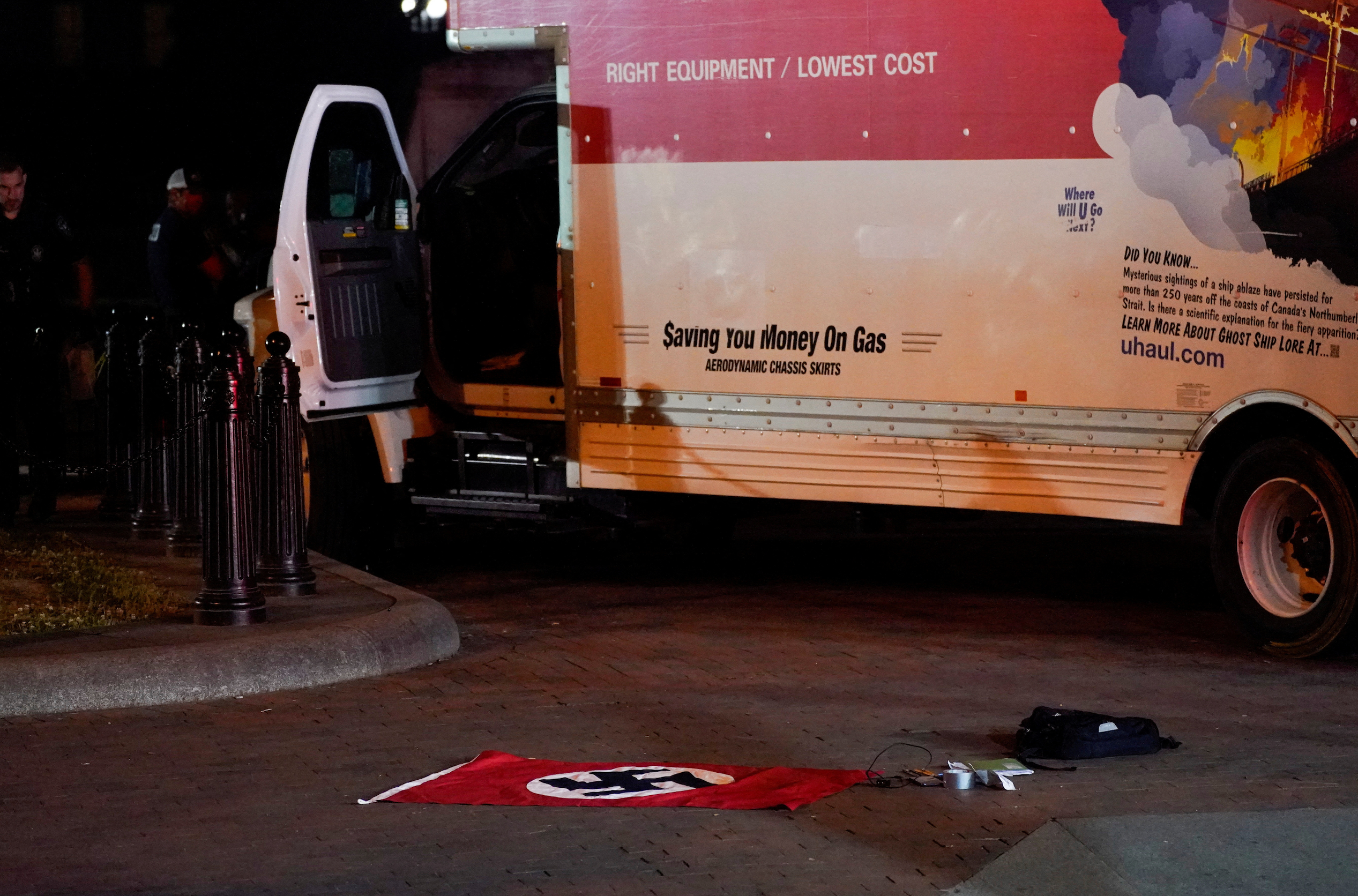 A Nazi flag and other objects recovered from a rented box truck are pictured on the ground as the U.S. Secret Service and other law enforcement agencies investigate the truck that crashed into security barriers at Lafayette Park