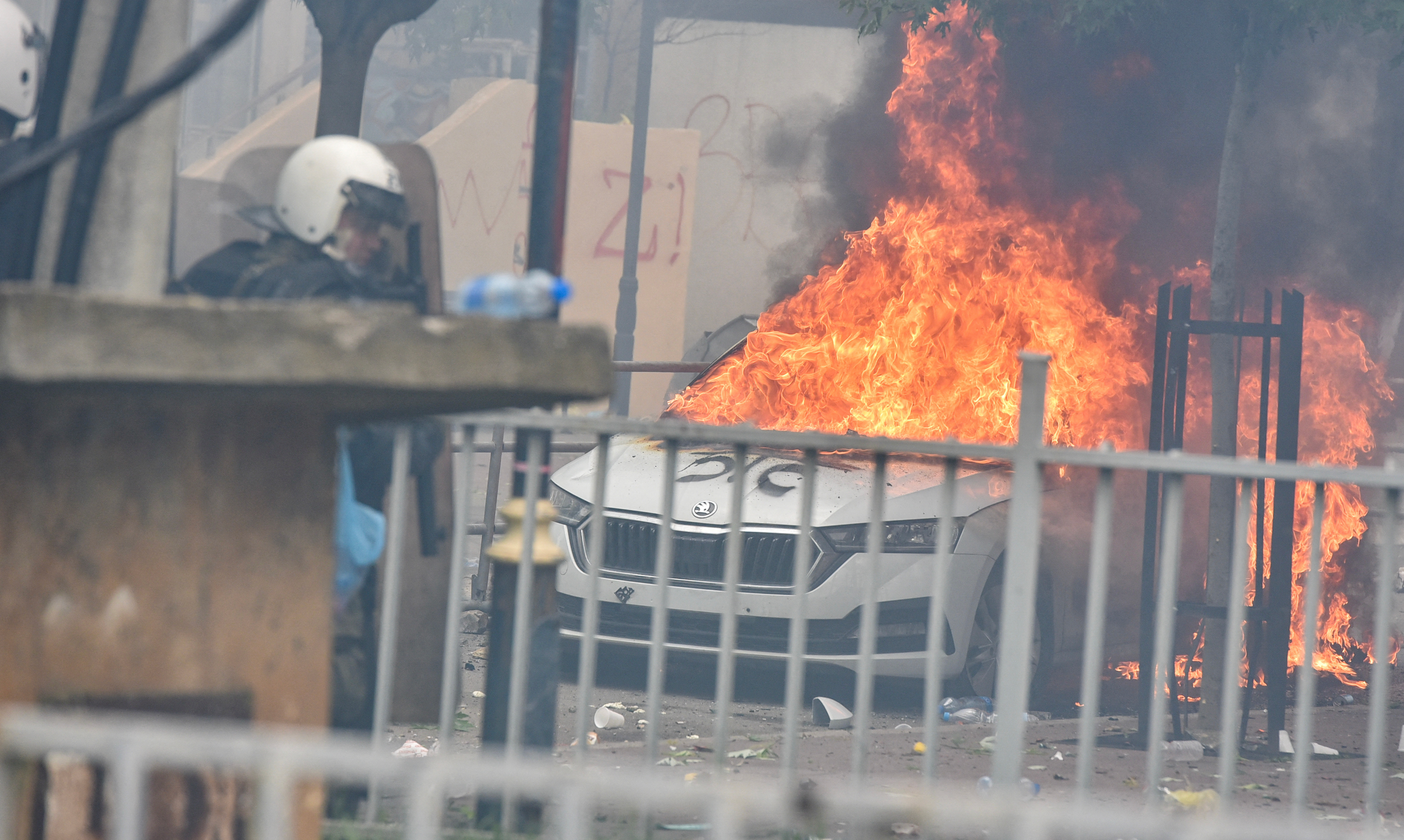 A car burns after NATO Kosovo Force (KFOR) soldiers clashed with local Kosovo Serb protesters at the entrance of the municipality office.
