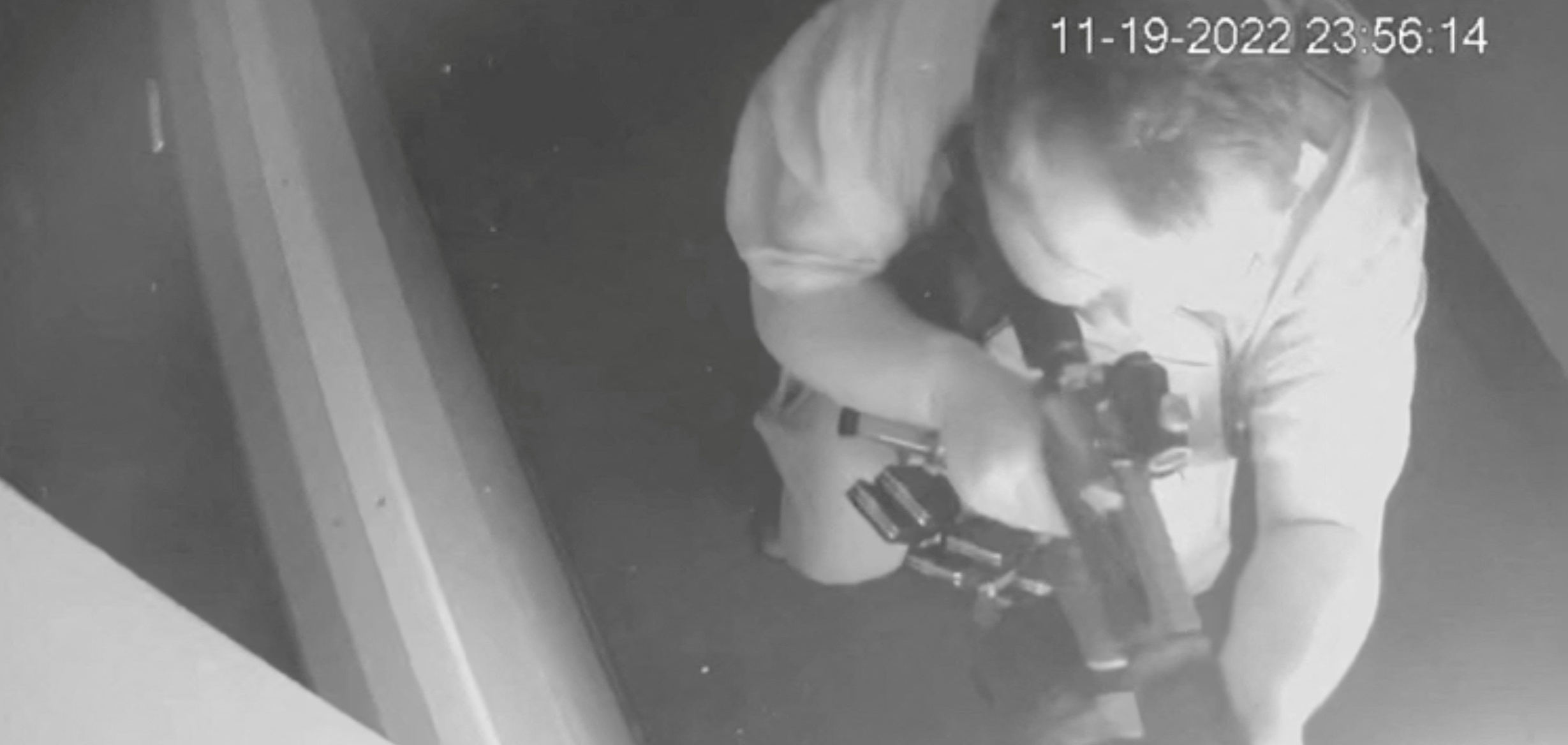 A black-and-white overhead view of the suspect Anderson Lee Aldrich firing a weapon into the LGBTQ nightclub Club