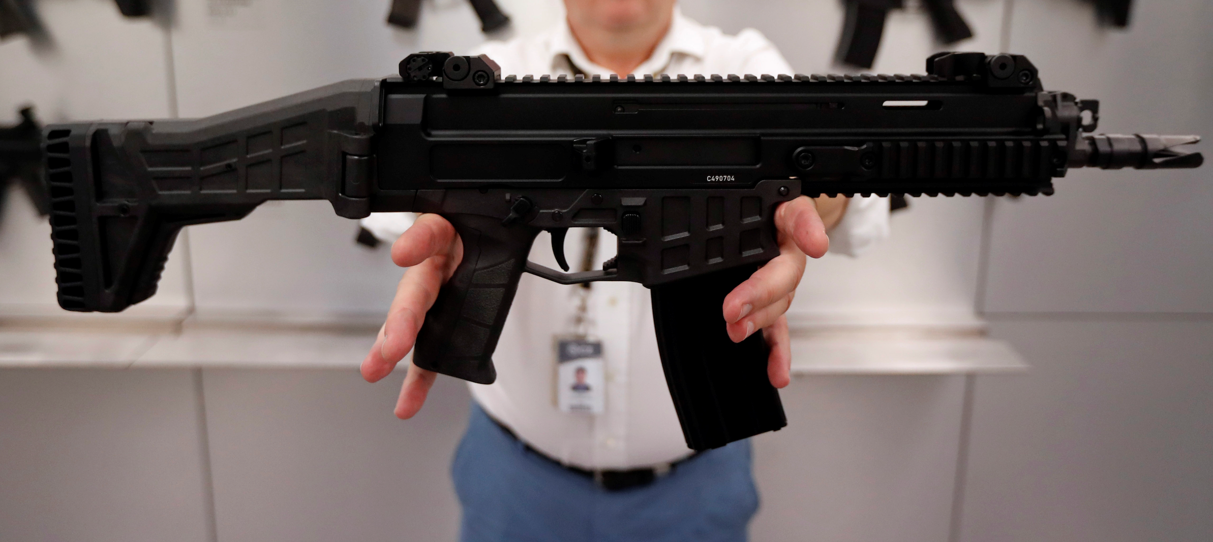 an employee presents a rifle inside a showroom of the Ceska Zbrojovka small arms factory