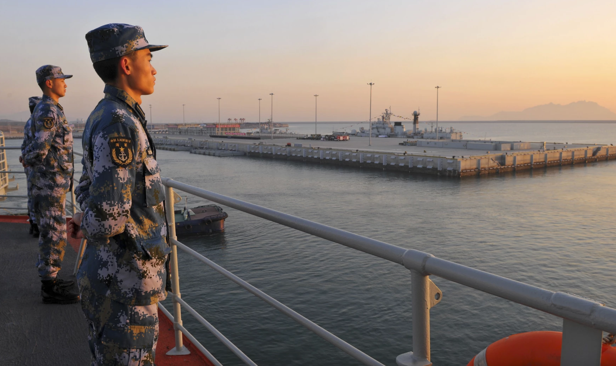 Chinese sailors man the rails on aircraft carrier Liaoning