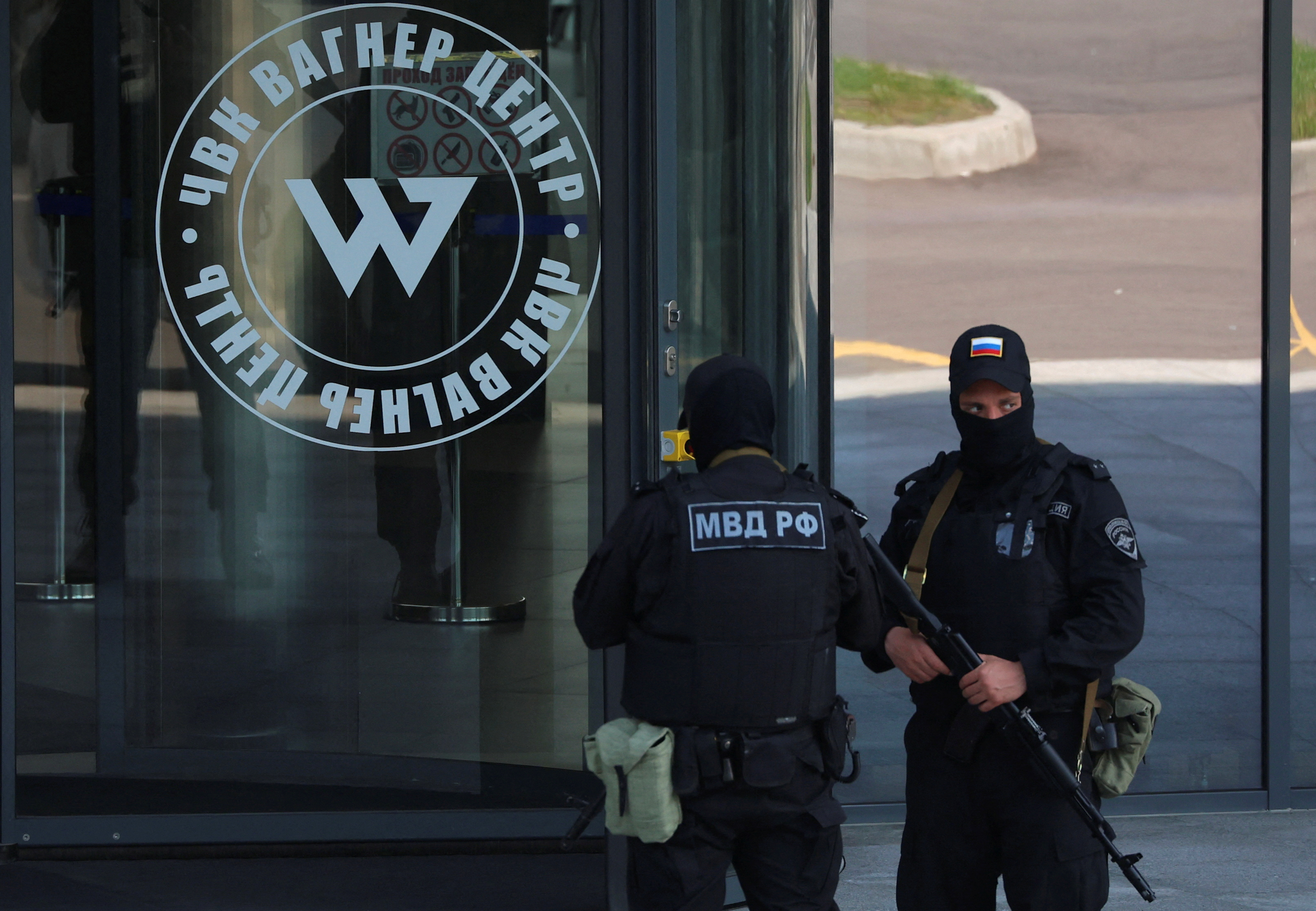 Russian law enforcement officers stand guard outside PMC Wagner Centr