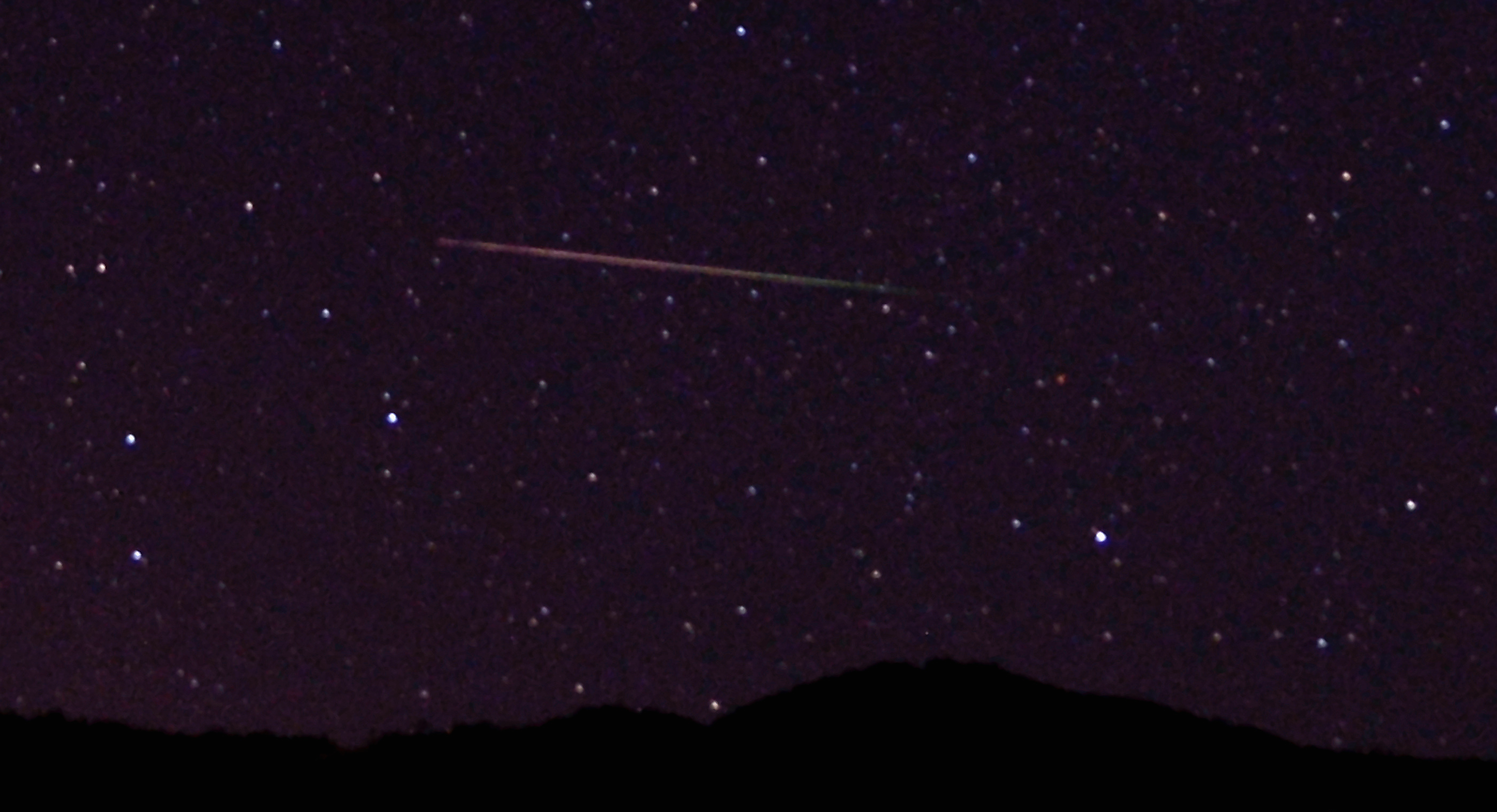 A meteor streaks over the northern skies in the early morning during the Perseid meteo