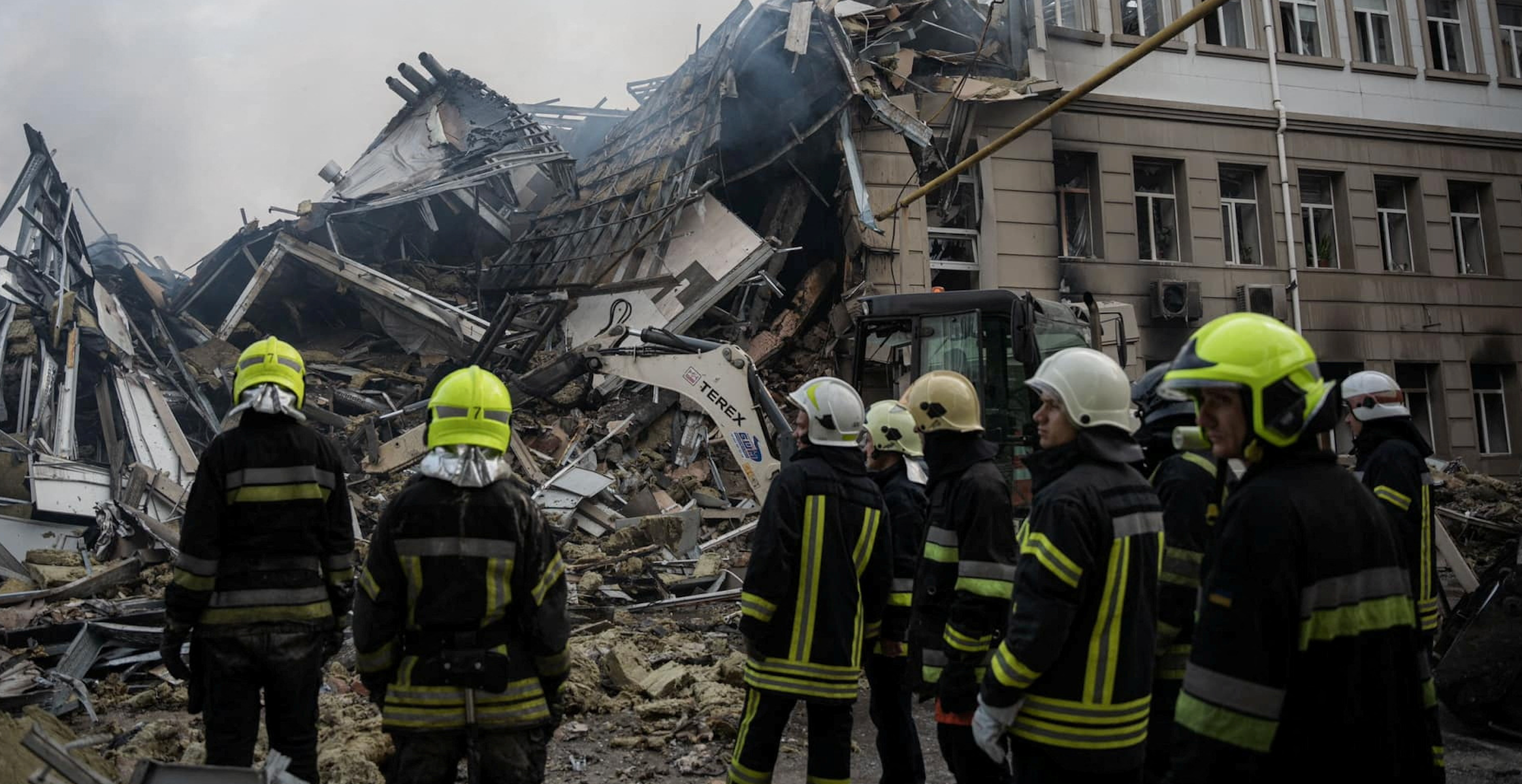  Rescuers work at a site of an administrative building heavily damaged by a Russian missile strike, amid Russia's attack on Ukraine