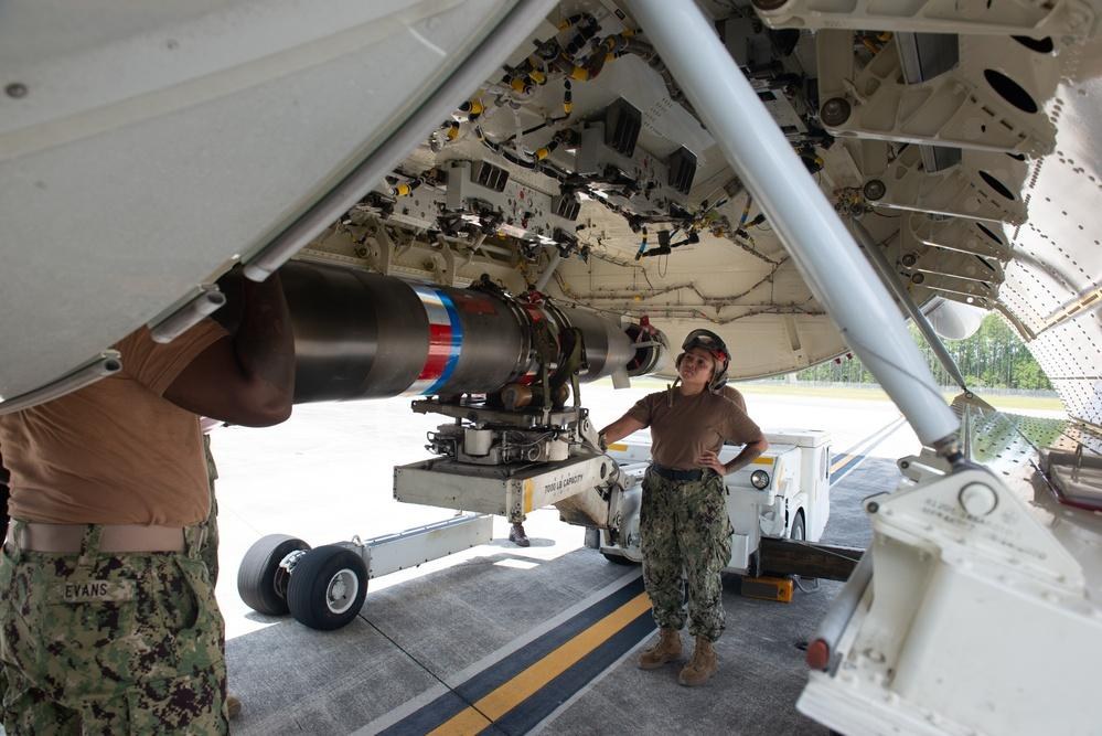 U.S. Navy sailors load a Mark 54 lightweight torpedo onto a P-8A Poseidon at Kadena Air Base, Japan, May 7, 2026. The image is illustrative of the Navy’s Silent Anvil concept, which remains in the industry-information stage.