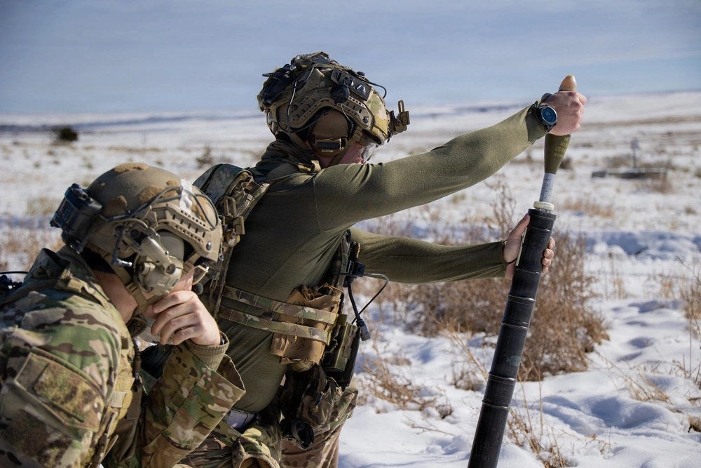 A Green Beret assigned to 3rd Battalion, 10th Special Forces Group (Airborne), hangs a 60mm mortar round during live-fire training in Colorado Springs, Colorado, Dec. 16, 2025. U.S. Army photo by Staff Sgt. David Cordova.