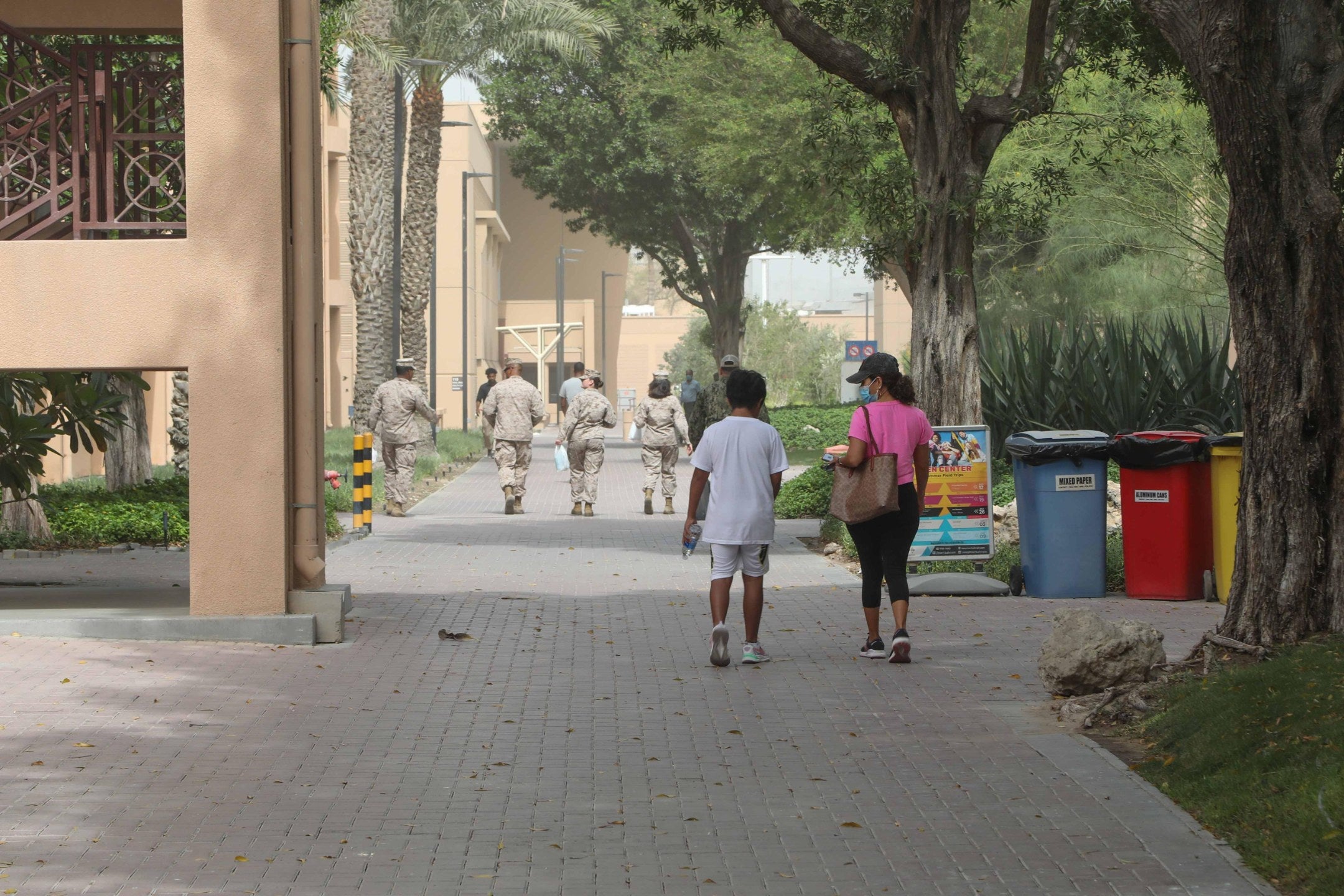 U.S. Navy family members walk through Naval Support Activity Bahrain. Nearly 1,300 military family members evacuated from Bahrain are being told they should not expect to return for the foreseeable future. U.S. Navy photo.