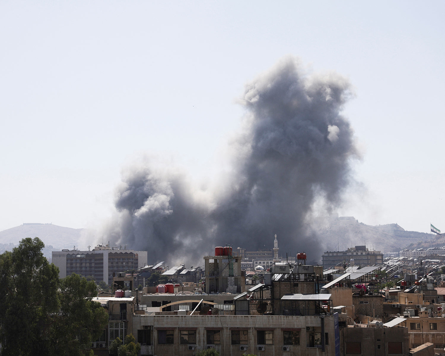 Israel strikes Damascus as fighting rages in southern Syria