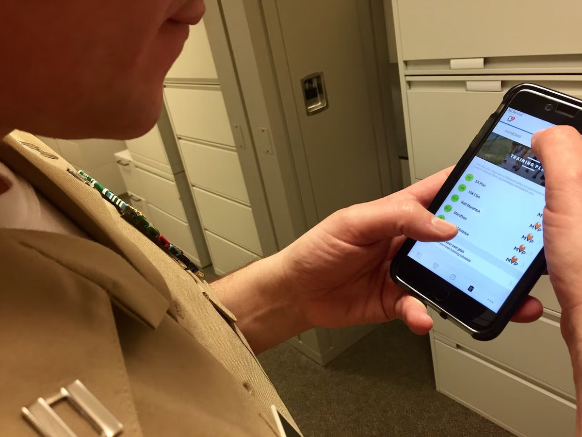 A service member looks at a fitness app on a smartphone at the Pentagon on Feb. 1, 2018, as the Defense Department reviewed security risks involving GPS-enabled fitness applications after Strava data exposed activity at military installations around the