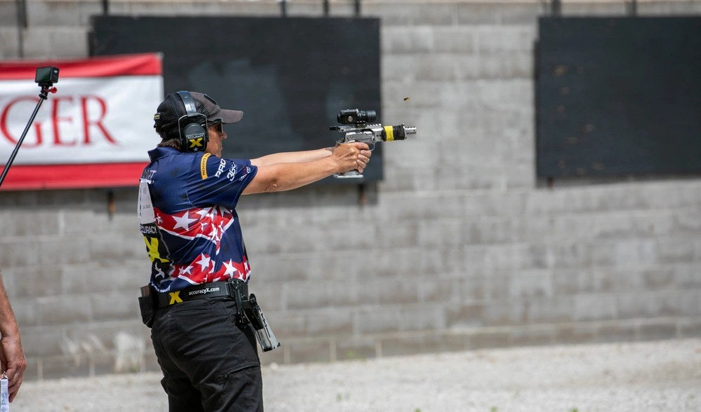 Retired U.S. Army Sgt. 1st Class Sally Talbott competes in the 2026 Bianchi Cup in Hallsville, Missouri, May 23, 2026. The image is illustrative; Talbott is not connected to the Justice Department's new firearm-rights restoration program.