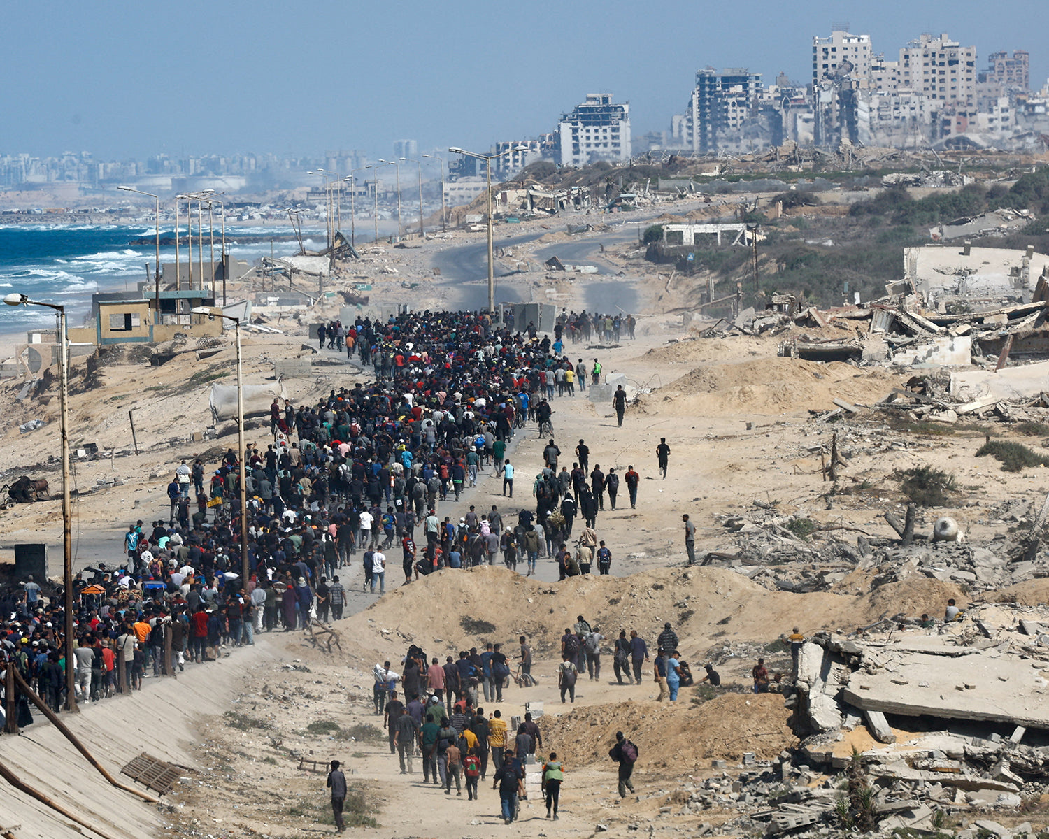 Palestinians stream to wrecked homes in Gaza, Israeli forces pull back under ceasefire