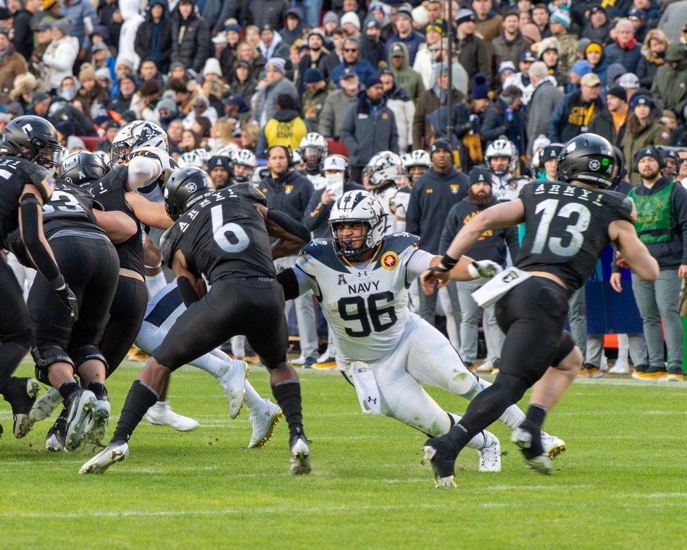 Navy defensive lineman Landon Robinson attempts a tackle during the 125th Army-Navy Game in Landover, Maryland, Dec. 14, 2024. Robinson, now a Marine second lieutenant, has earned a spot on the Cincinnati Bengals’ 53-man roster. (U.S. Army photo by Staff