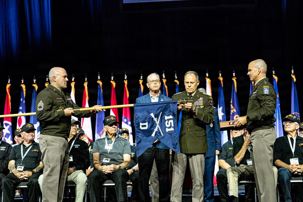U.S. Army Gen. Christopher C. LaNeve, vice chief of staff of the Army, attaches the Presidential Unit Citation streamer to the guidon of Company D, 151st Infantry Regiment, during a ceremony in Indianapolis, Aug. 29, 2026. The Indiana Rangers received
