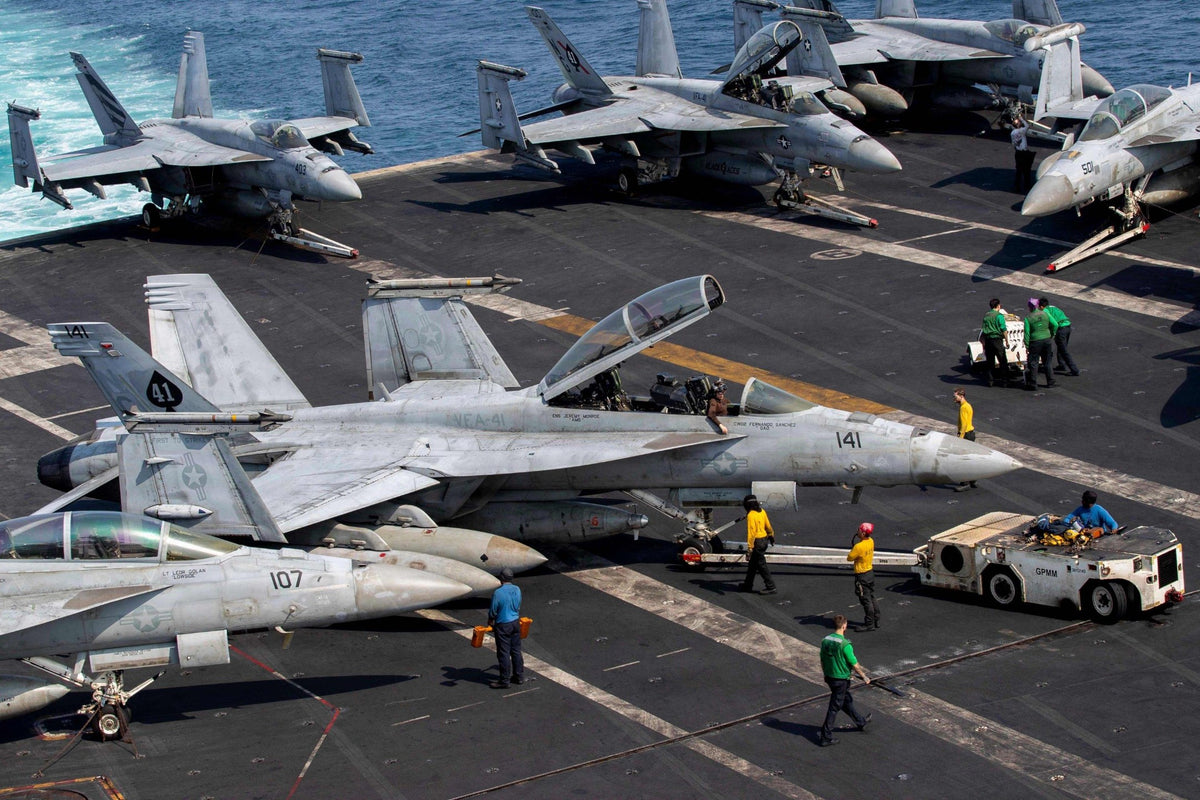 Two F/A-18E Super Hornets fly over USS Abraham Lincoln during operations in the U.S. 7th Fleet area on September 23, 2026. The carrier is returning to San Diego following an extended deployment during which the Navy reported eight suicide attempts across