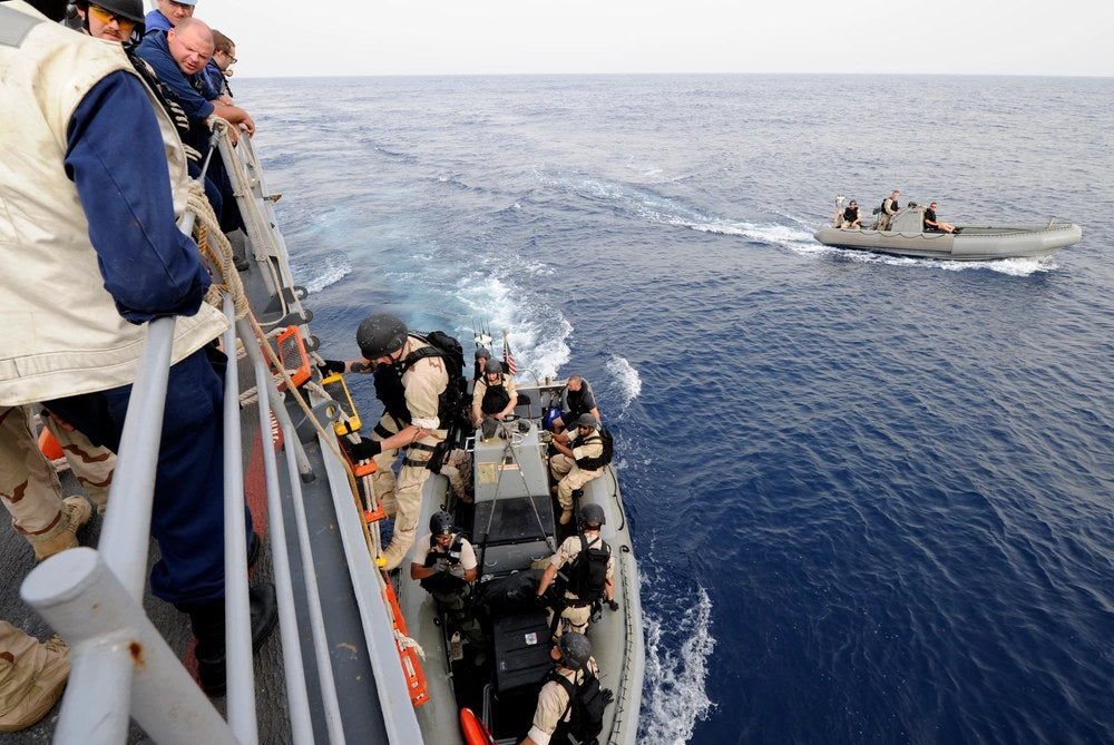 Illustrative file photo. A U.S. Navy visit, board, search and seizure team prepares to inspect a vessel in the Gulf of Aden in July 2011. New reporting says false intelligence produced with help from an AI chatbot led the U.S. military to prepare an