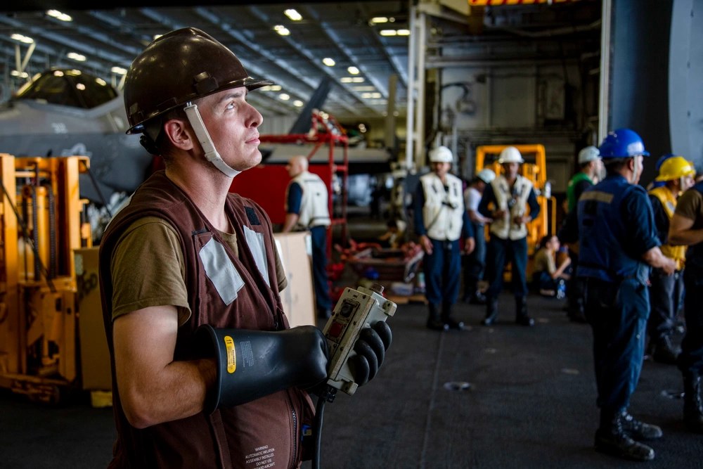 Seaman Bailey Szramowski operates equipment aboard USS Abraham Lincoln during a replenishment-at-sea in the Philippine Sea on June 6, 2022. Szramowski pleaded guilty Sept. 14, 2026, in a federal fentanyl case involving Navy service members. U.S. Navy