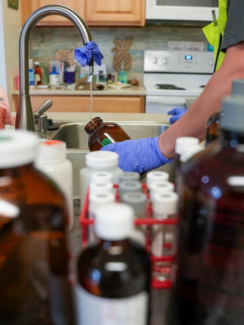 A Navy contractor collects a drinking-water sample at a military housing residence in Hawaii in April 2025. Separately, families at the U.S. Air Force Academy in Colorado have reported positive at-home lead tests on plumbing fixtures and detectable lead