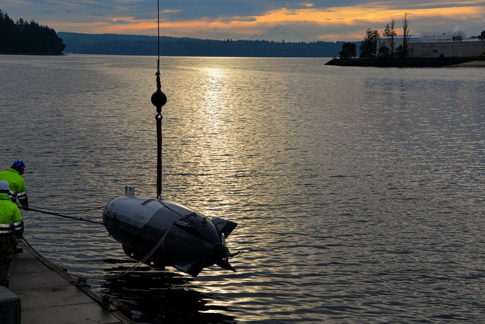 U.S. Navy sailors train with an Anduril Dive-LD large unmanned undersea vehicle in December 2024. CENTCOM says a Dive-LD that malfunctioned near the Strait of Hormuz was later recovered by Iran. (U.S. Navy photo)