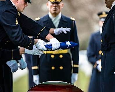 Soldiers with the 3rd U.S. Infantry Regiment, The Old Guard, fold the American flag during military funeral honors at Arlington National Cemetery in January 2022. The ceremony pictured is unrelated to the fraud case. (Elizabeth Fraser/Arlington National
