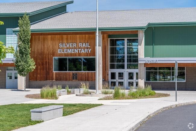 Law enforcement responds to Silver Rail Elementary School in Bend, Oregon, on October 15, 2026, after a shooting killed three children and a teacher. Police said an armed community member followed the gunman inside and fatally shot him. (AP Photo/Joe