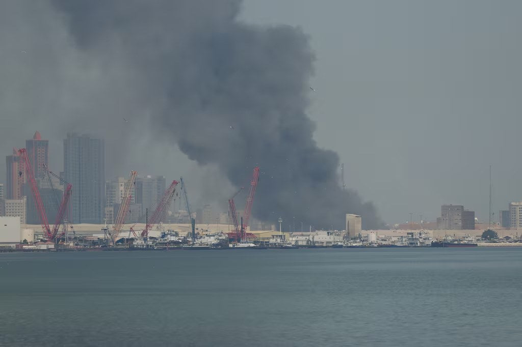Smoke rises from the U.S. Navy’s Fifth Fleet headquarters in Manama, Bahrain, following an Iranian missile strike on Feb. 28, 2026. A newly released Pentagon inspector-general report says earlier Iranian attacks damaged or destroyed hundreds of
