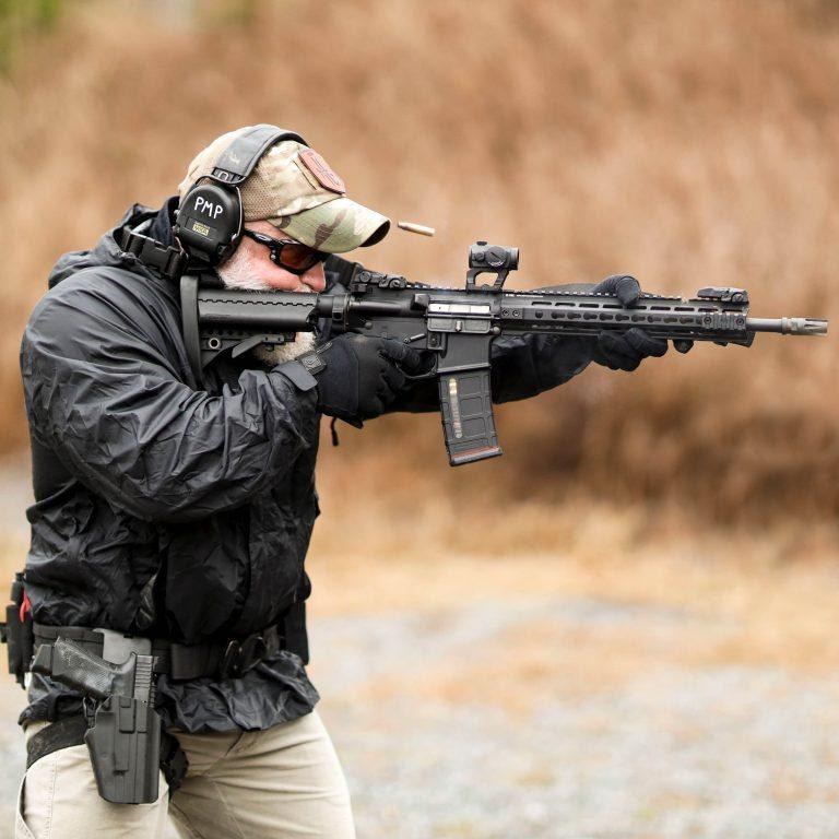 A U.S. Fish and Wildlife Service special agent carries an AR-15-style rifle at a Connecticut firing range. Families of Sandy Hook shooting victims filed new Supreme Court briefs on October 28, 2026, urging the justices to uphold restrictions on